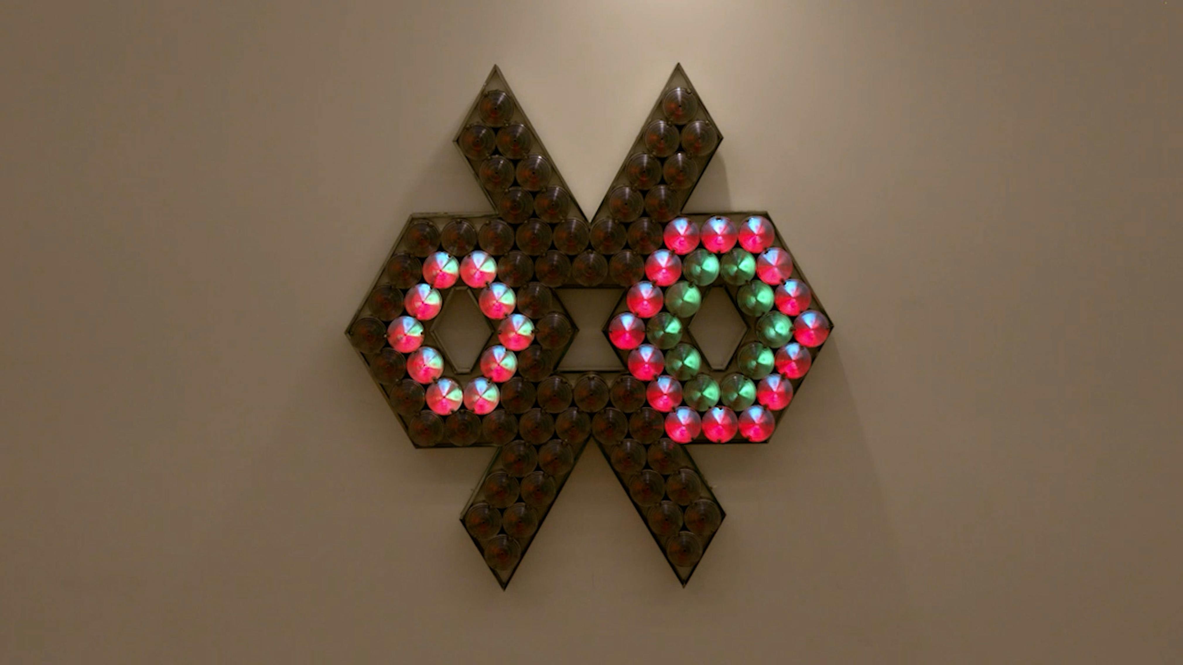 An electronically powered light sculpture with different color lightbulbs lighting up in different sequences.