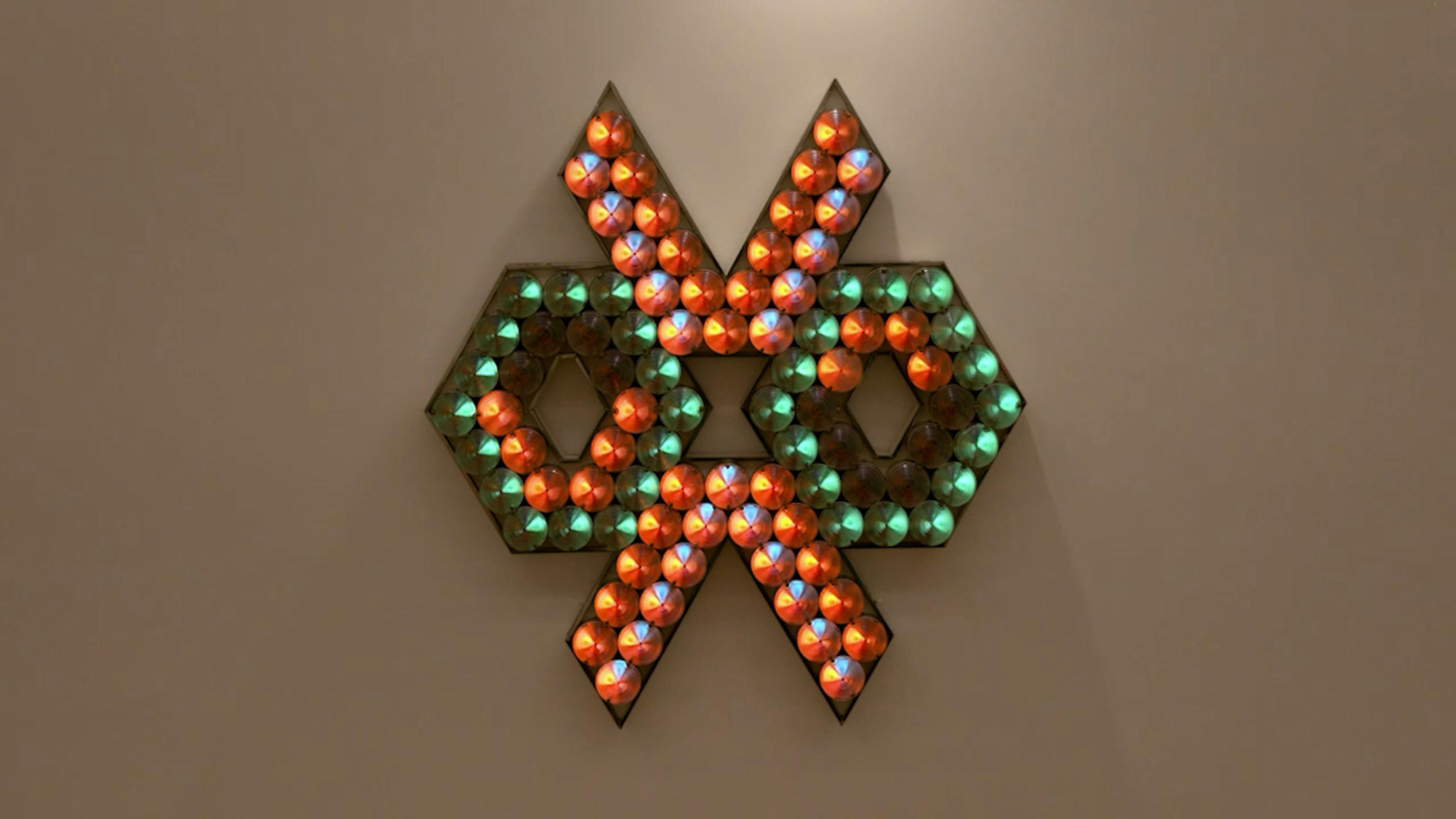 An electronically powered light sculpture with different color lightbulbs lighting up in different sequences.
