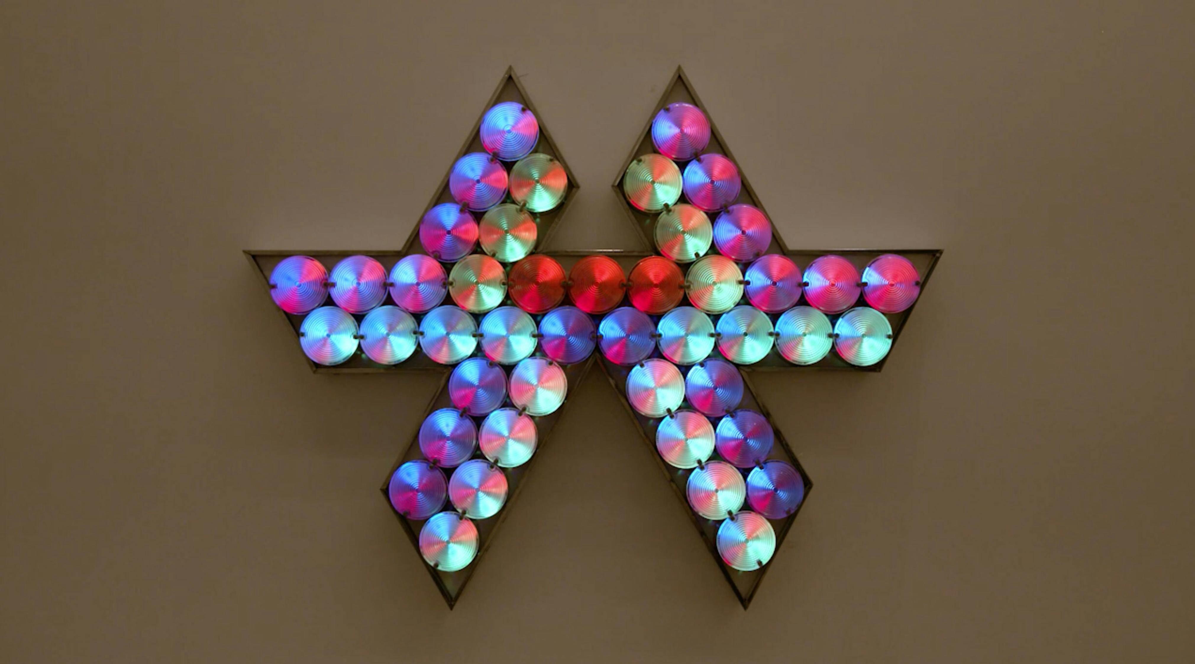 An electronically powered light sculpture with different color lightbulbs lighting up in different sequences.