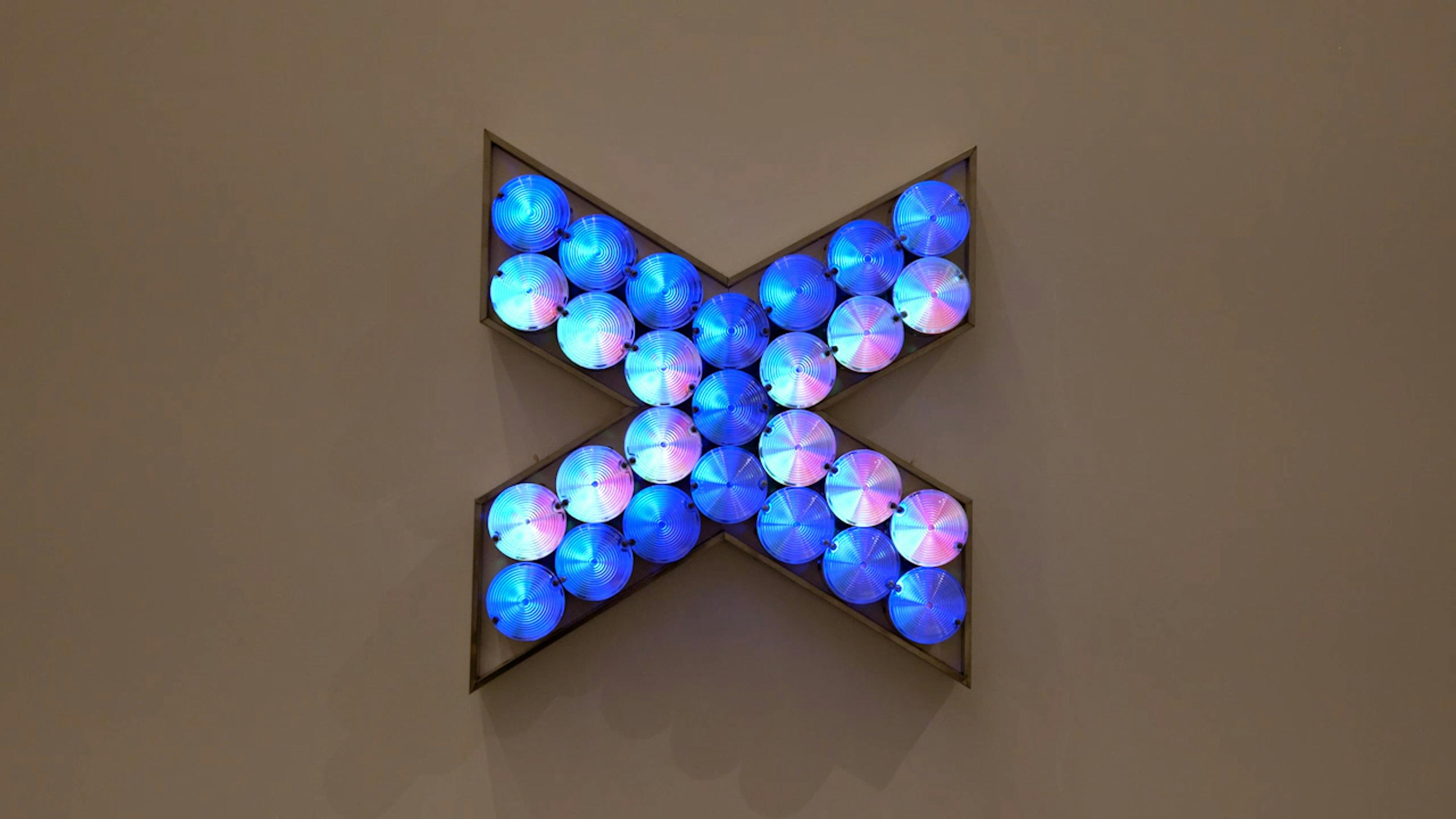 An electronically powered light sculpture with different color lightbulbs lighting up in different sequences.