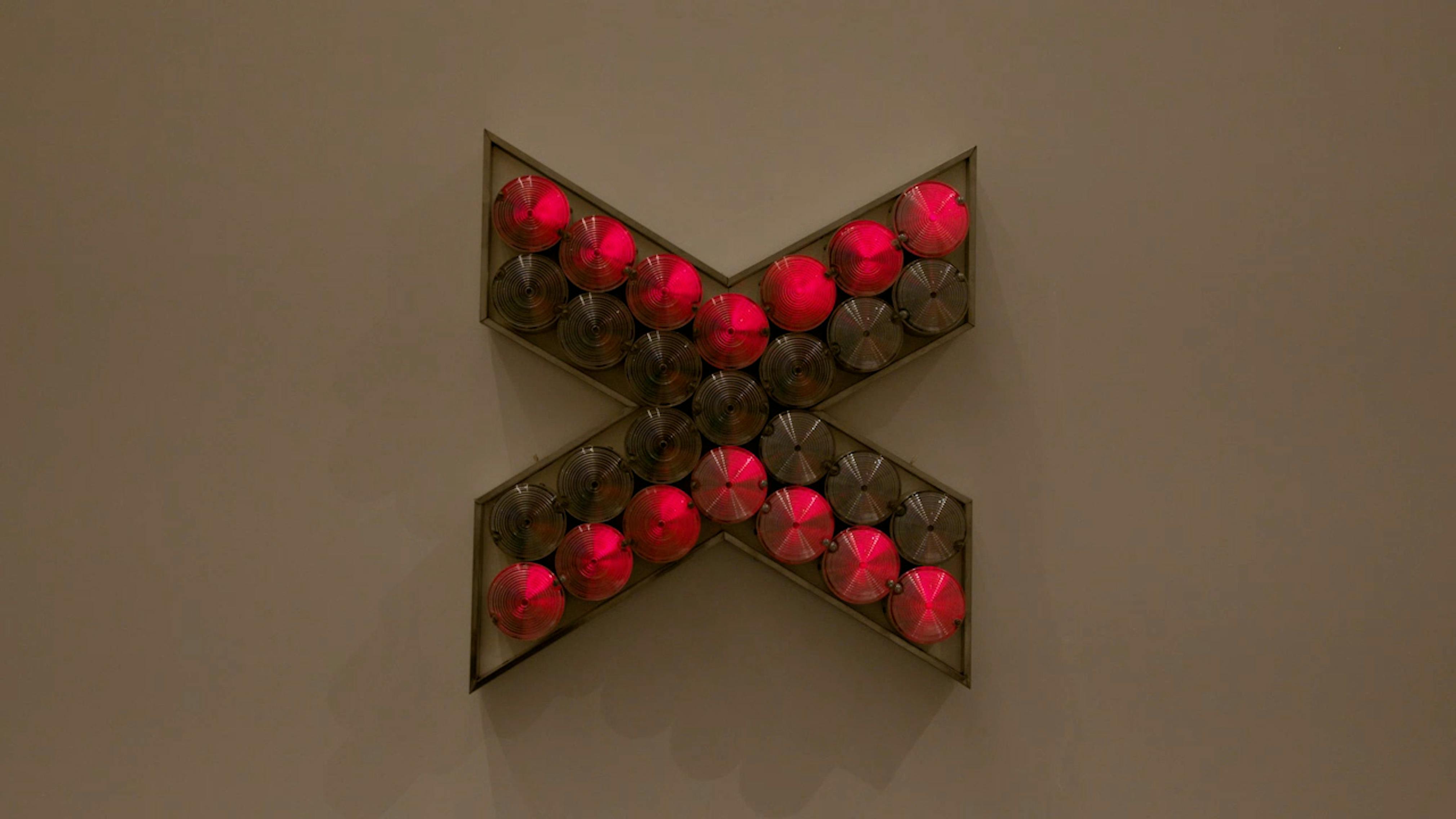 An electronically powered light sculpture with different color lightbulbs lighting up in different sequences.