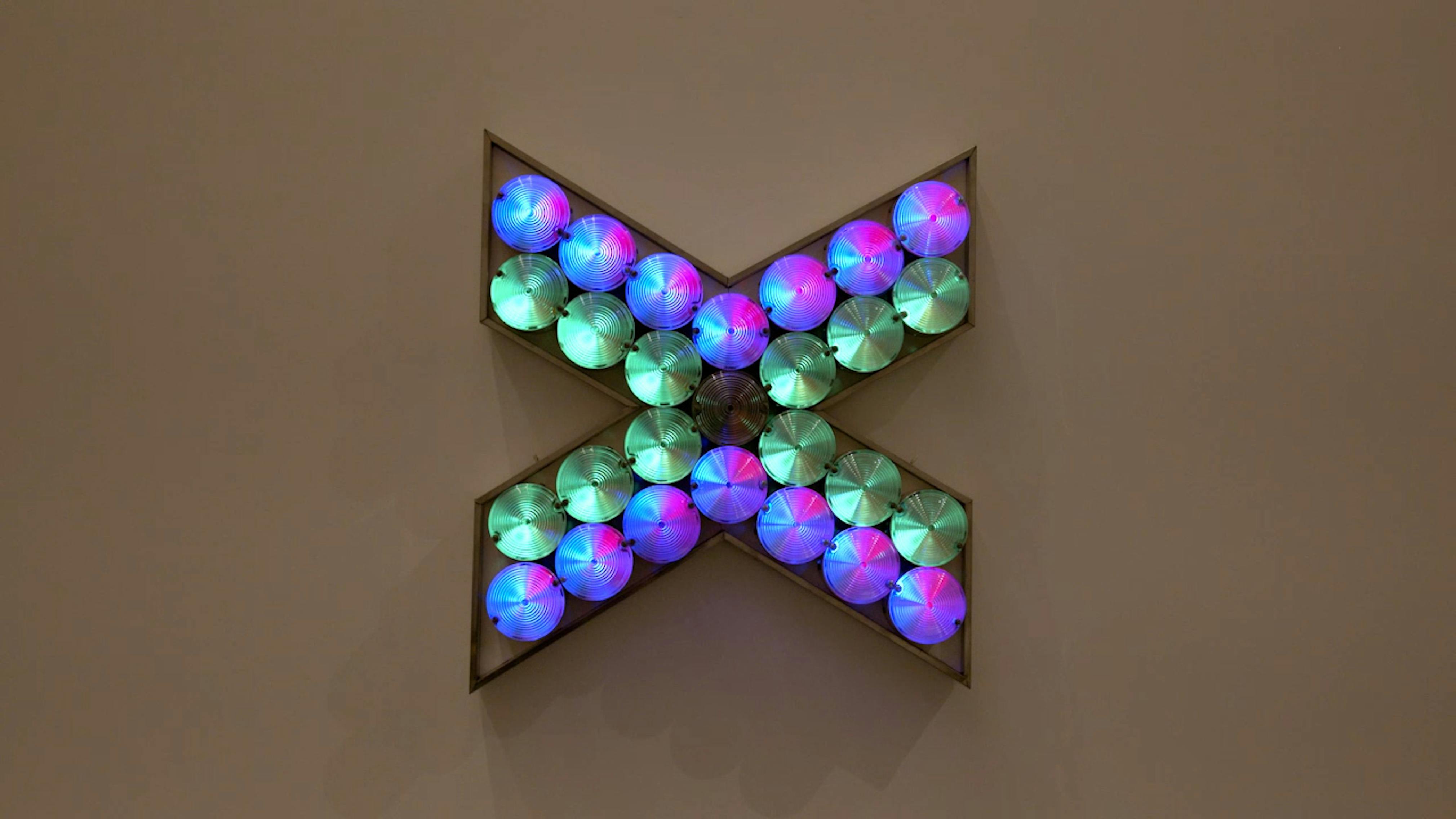 An electronically powered light sculpture with different color lightbulbs lighting up in different sequences.