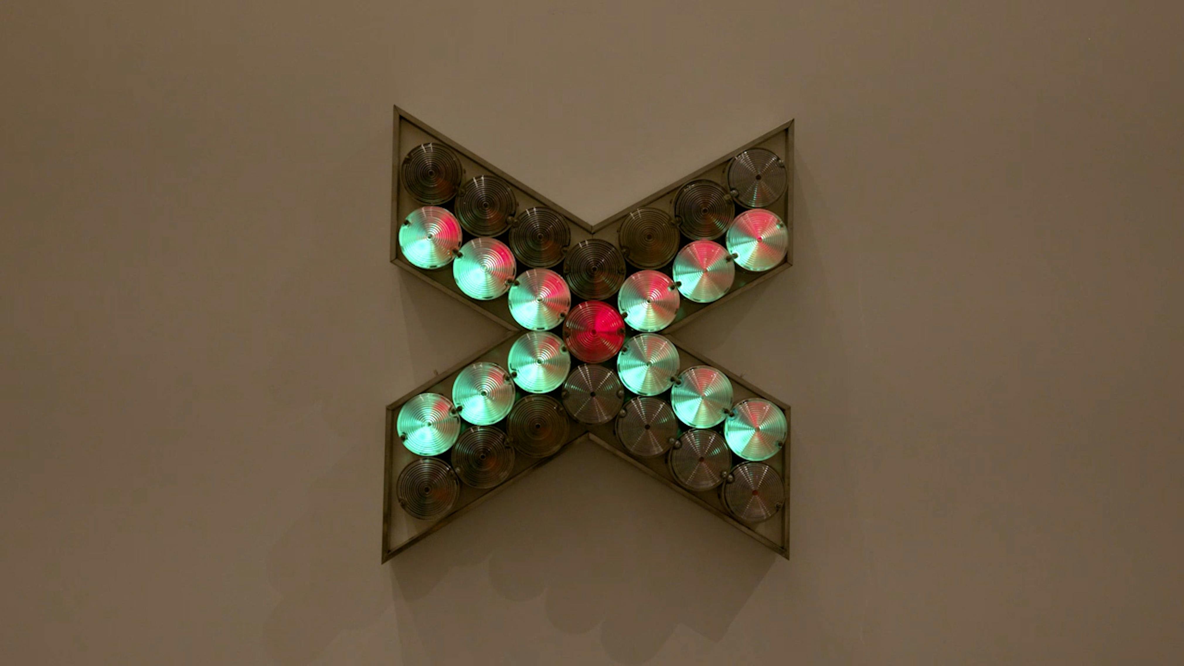 An electronically powered light sculpture with different color lightbulbs lighting up in different sequences.