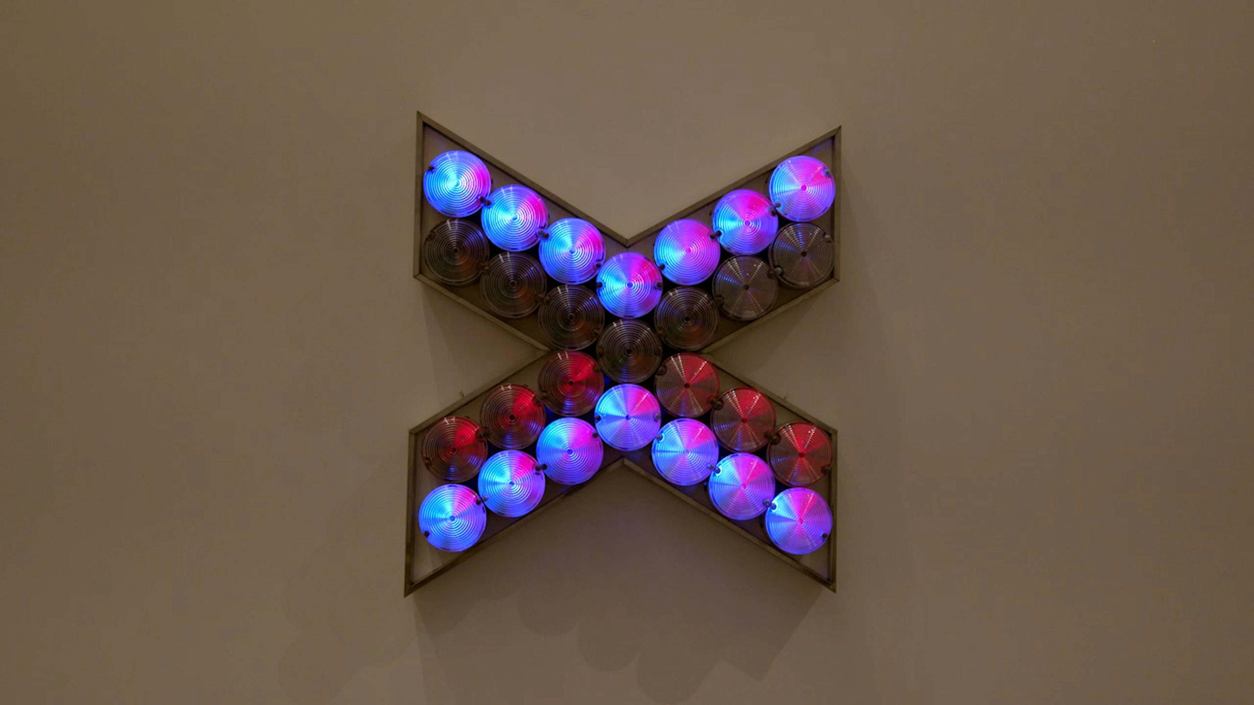 An electronically powered light sculpture with different color lightbulbs lighting up in different sequences.