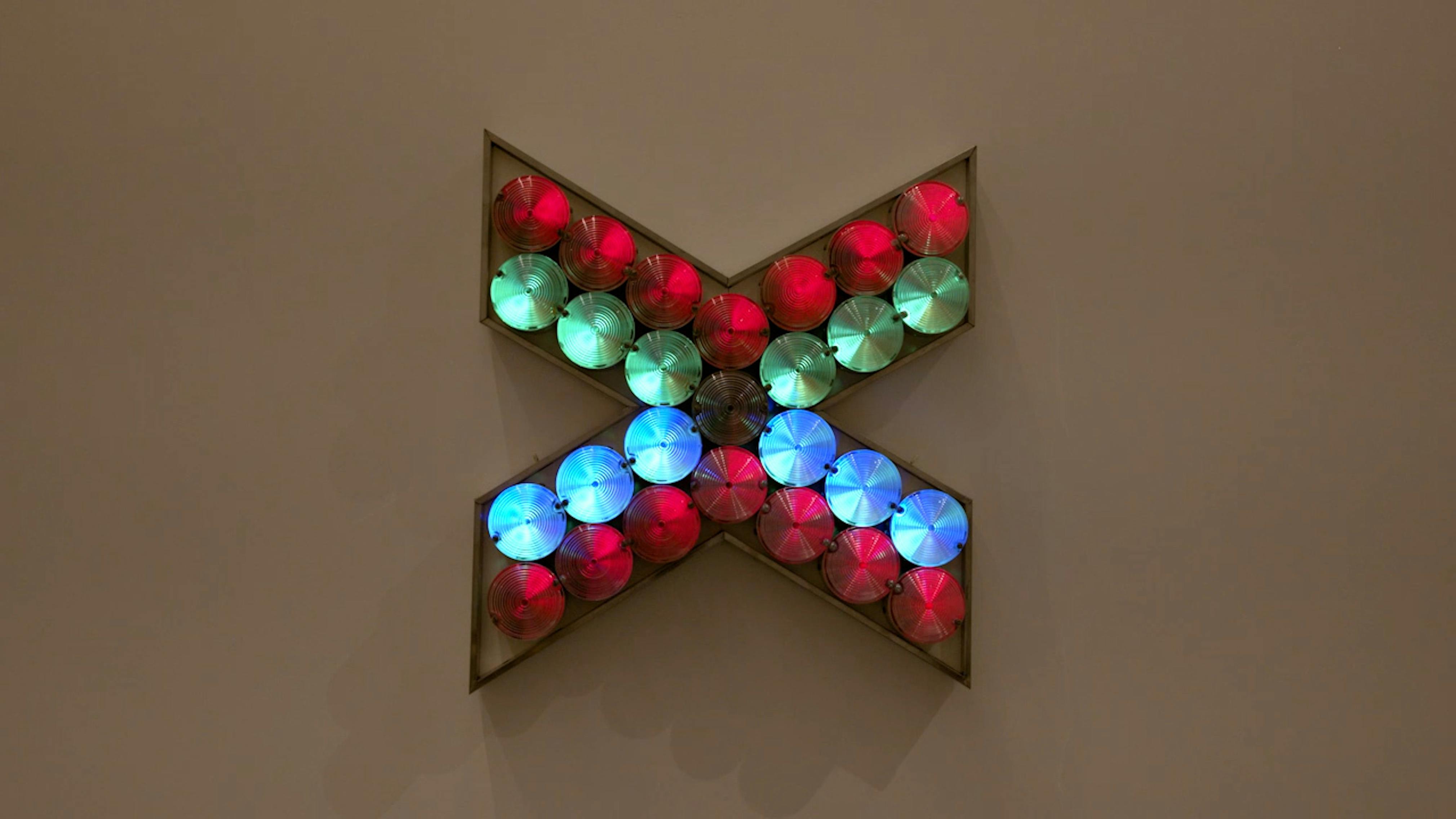 An electronically powered light sculpture with different color lightbulbs lighting up in different sequences.