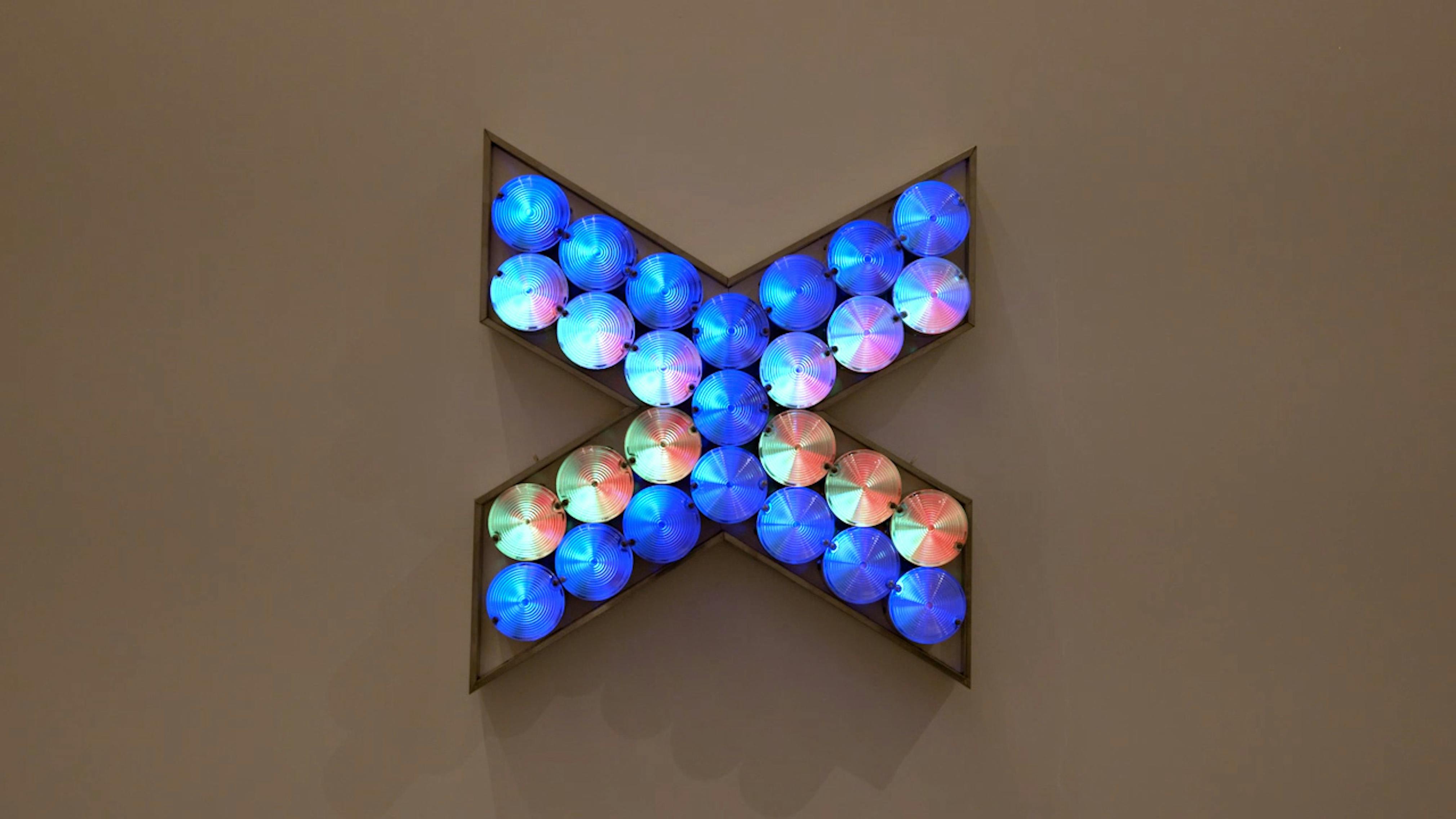 An electronically powered light sculpture with different color lightbulbs lighting up in different sequences.
