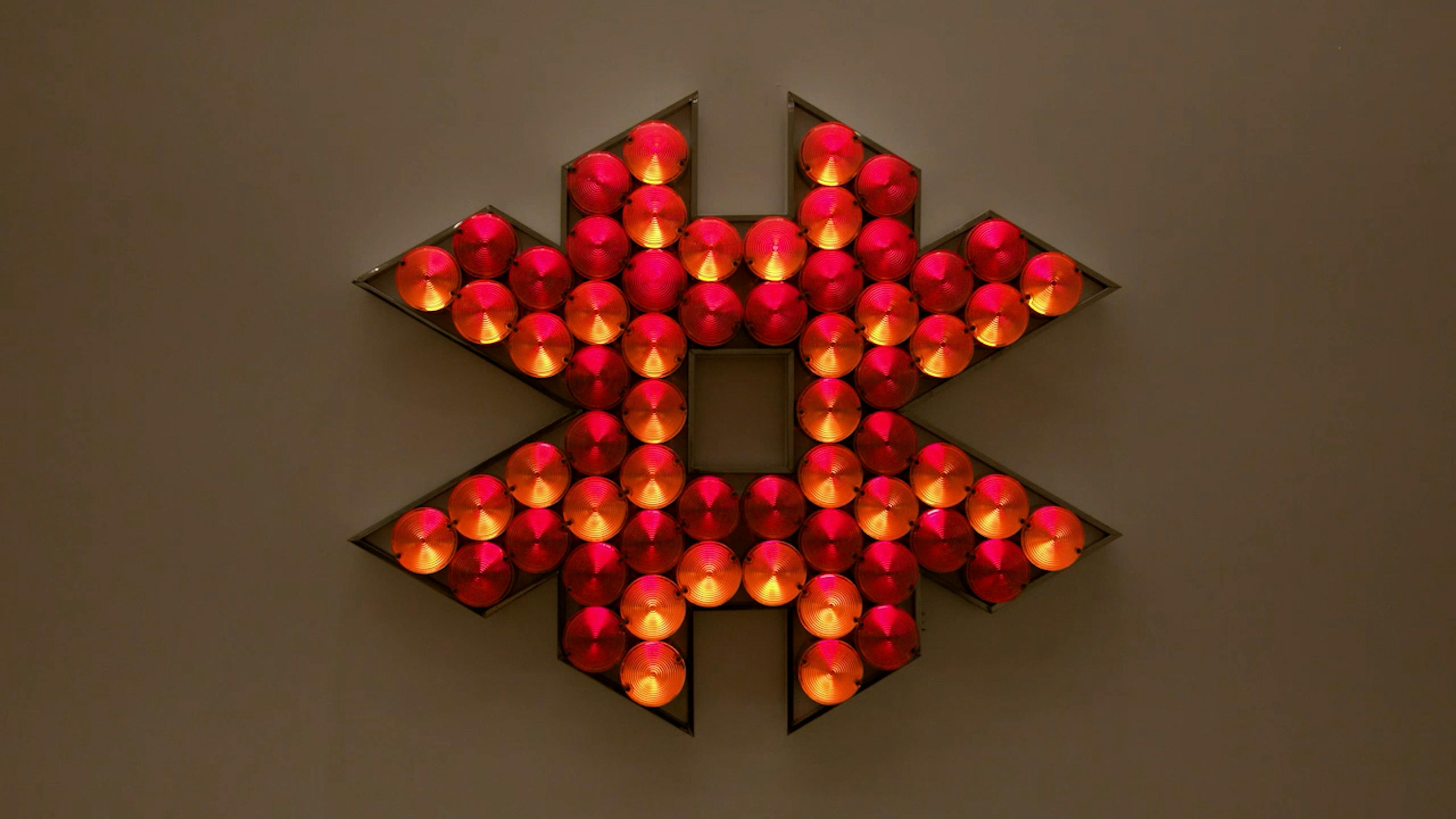 An electronically powered light sculpture with different color lightbulbs lighting up in different sequences.