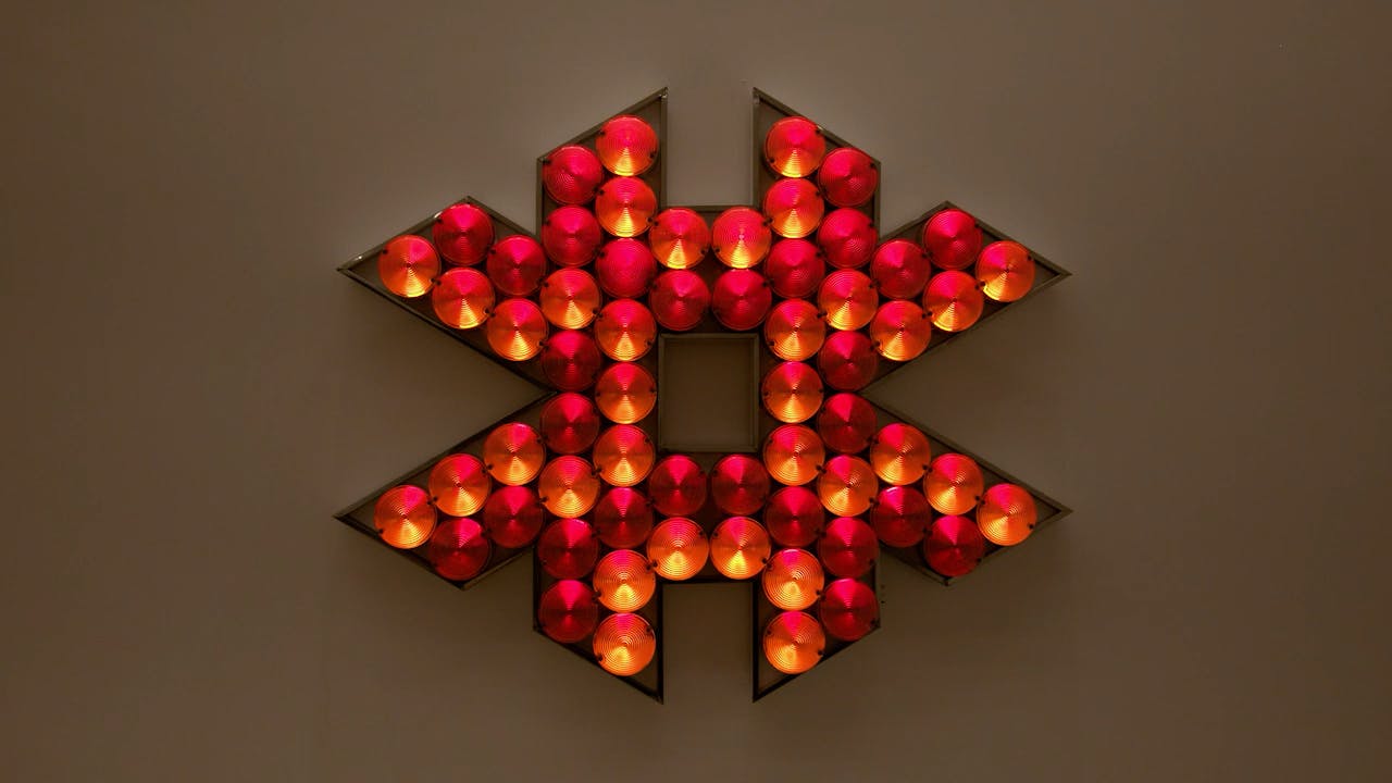 An electronically powered light sculpture with different color lightbulbs lighting up in different sequences.