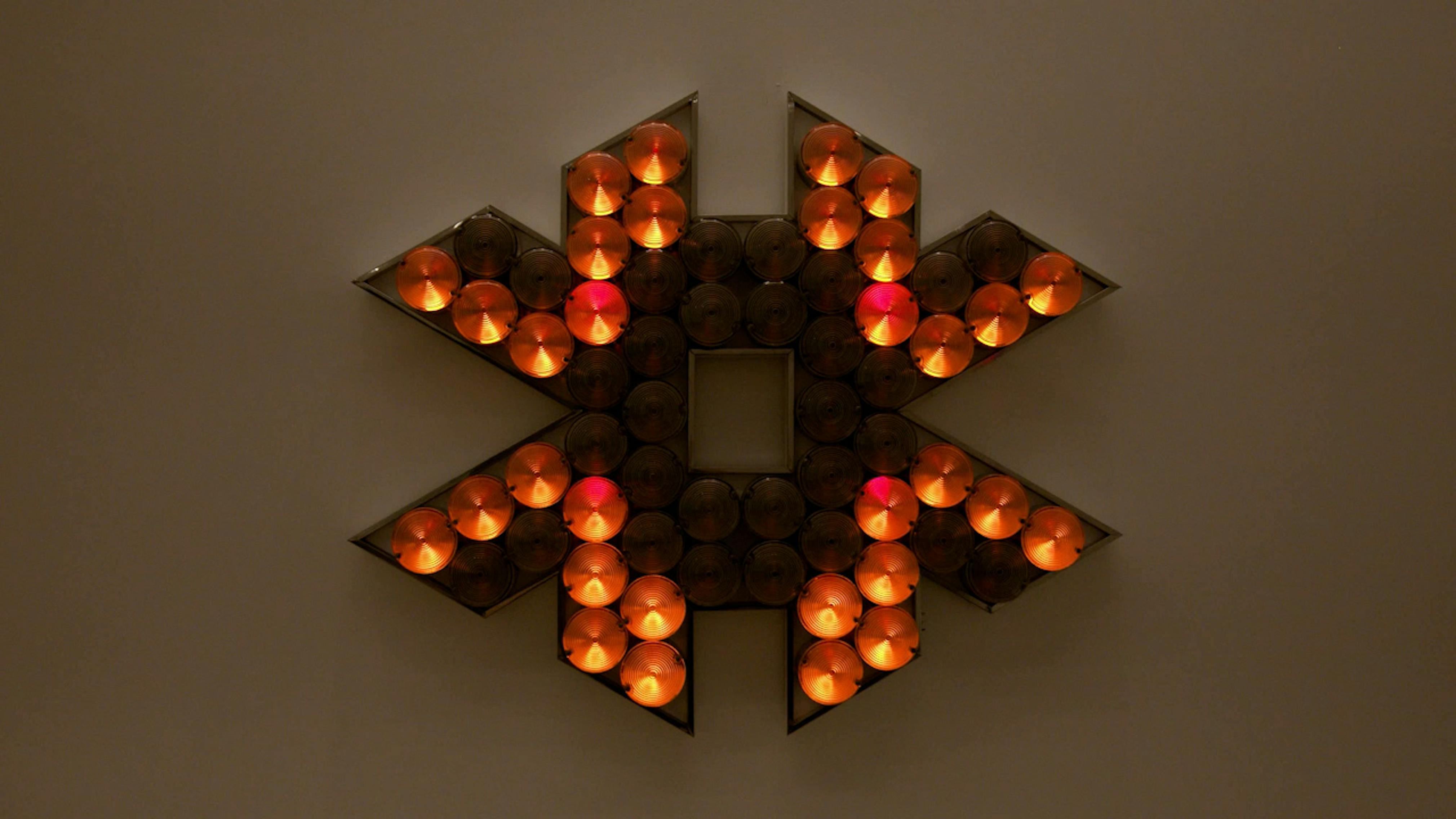 An electronically powered light sculpture with different color lightbulbs lighting up in different sequences.