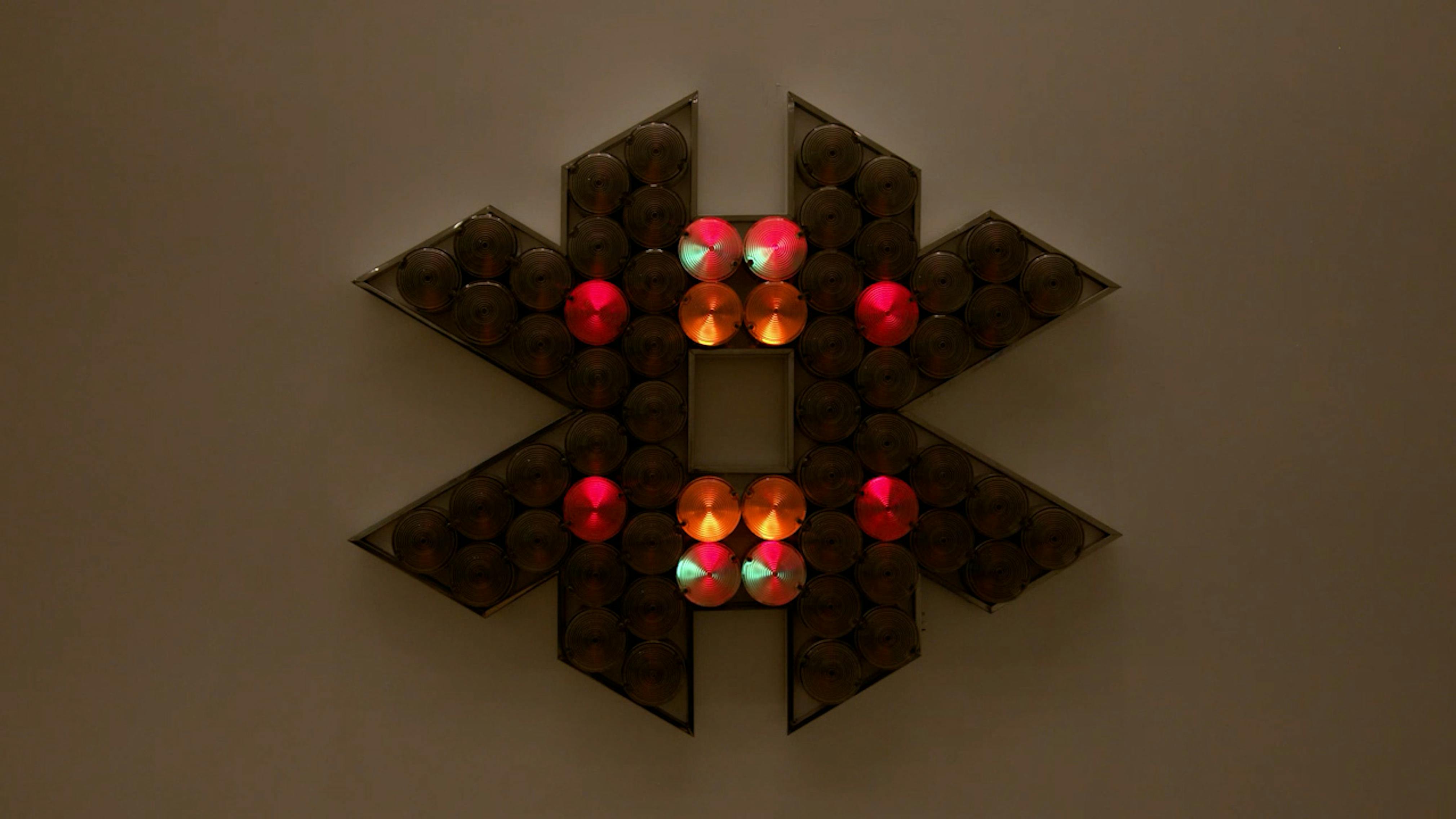 An electronically powered light sculpture with different color lightbulbs lighting up in different sequences.