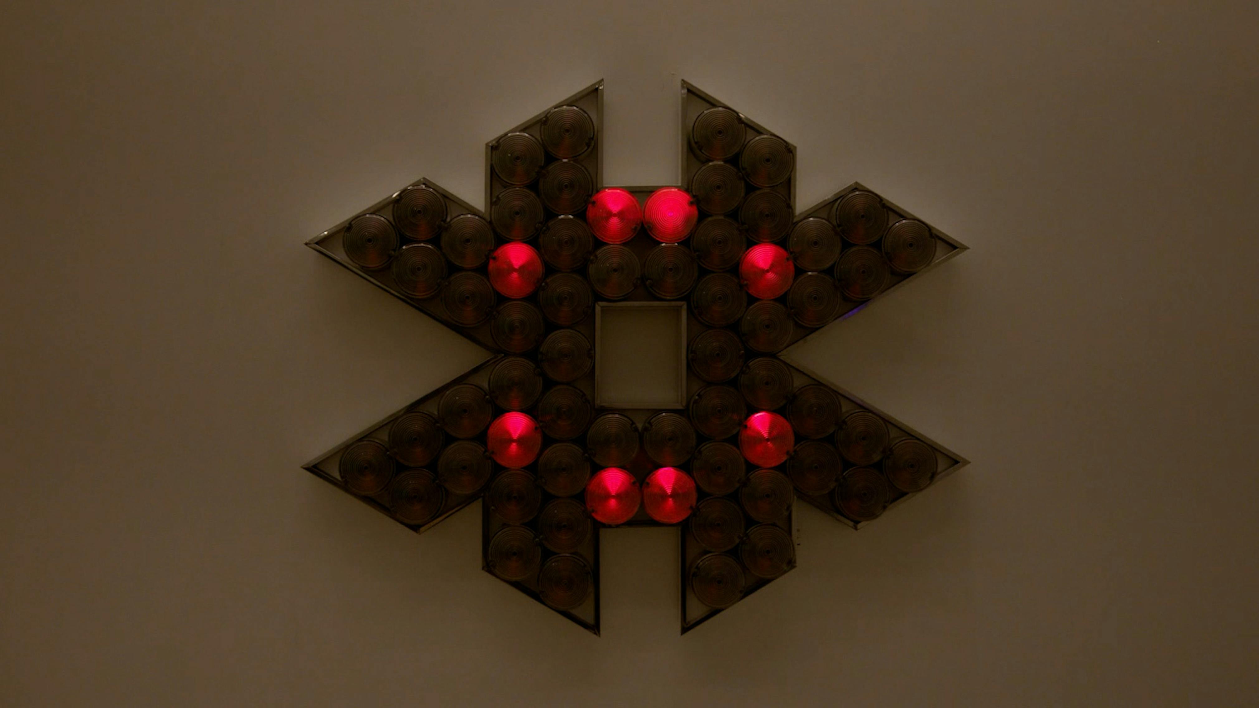 An electronically powered light sculpture with different color lightbulbs lighting up in different sequences.