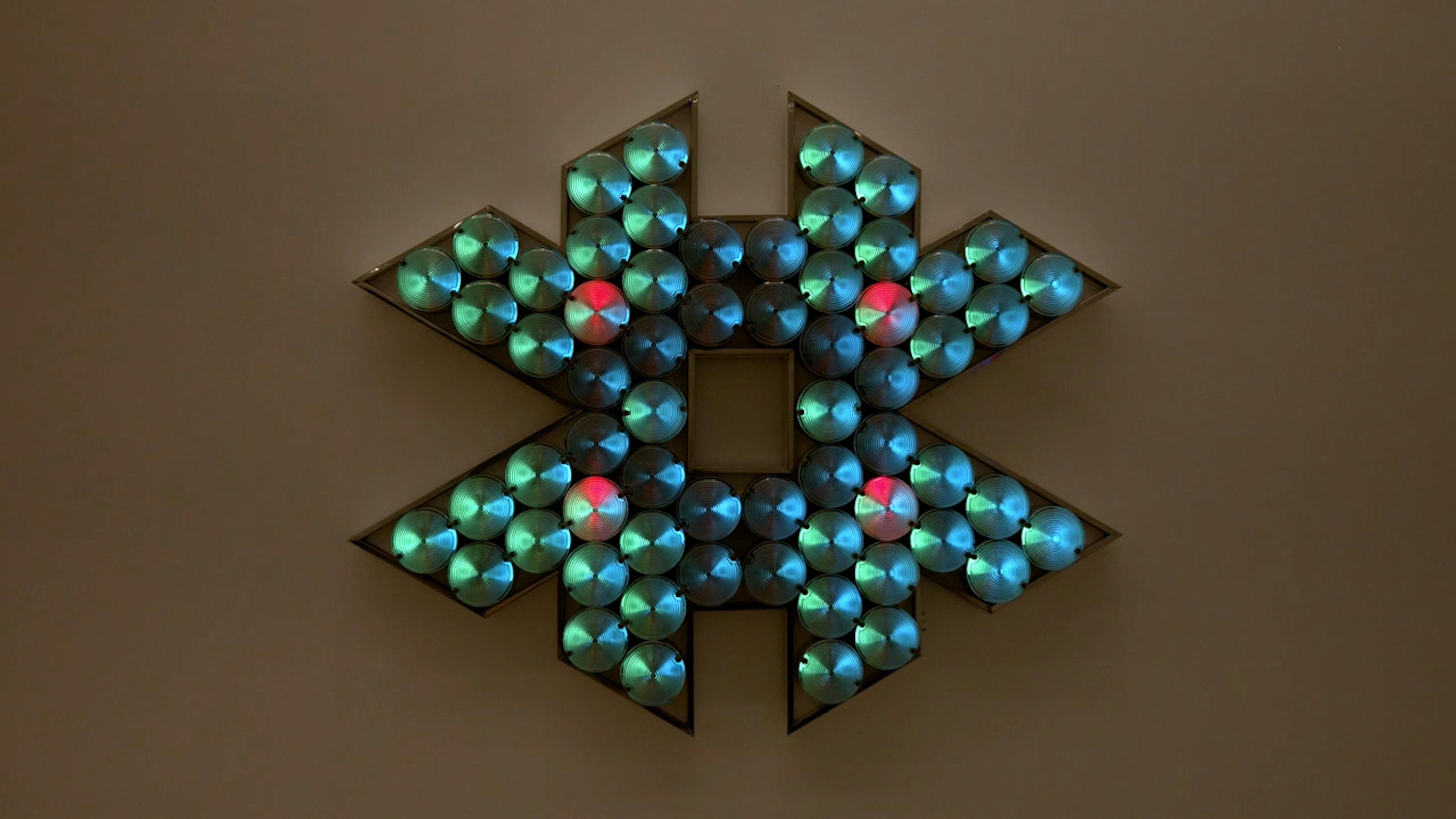An electronically powered light sculpture with different color lightbulbs lighting up in different sequences.