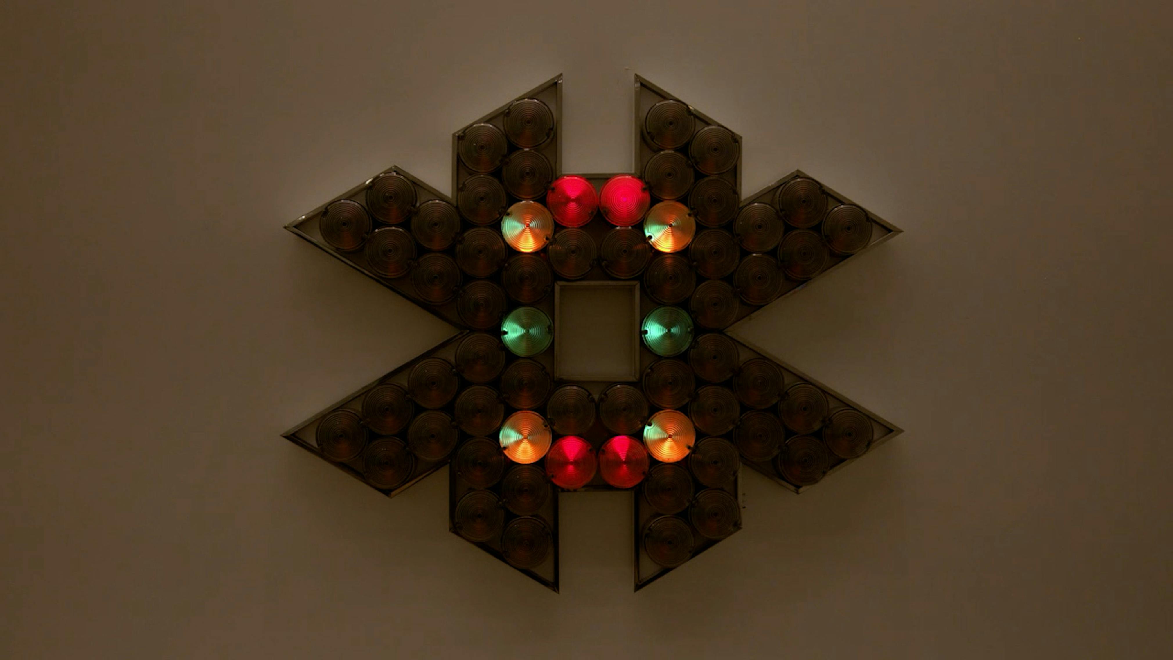 An electronically powered light sculpture with different color lightbulbs lighting up in different sequences.