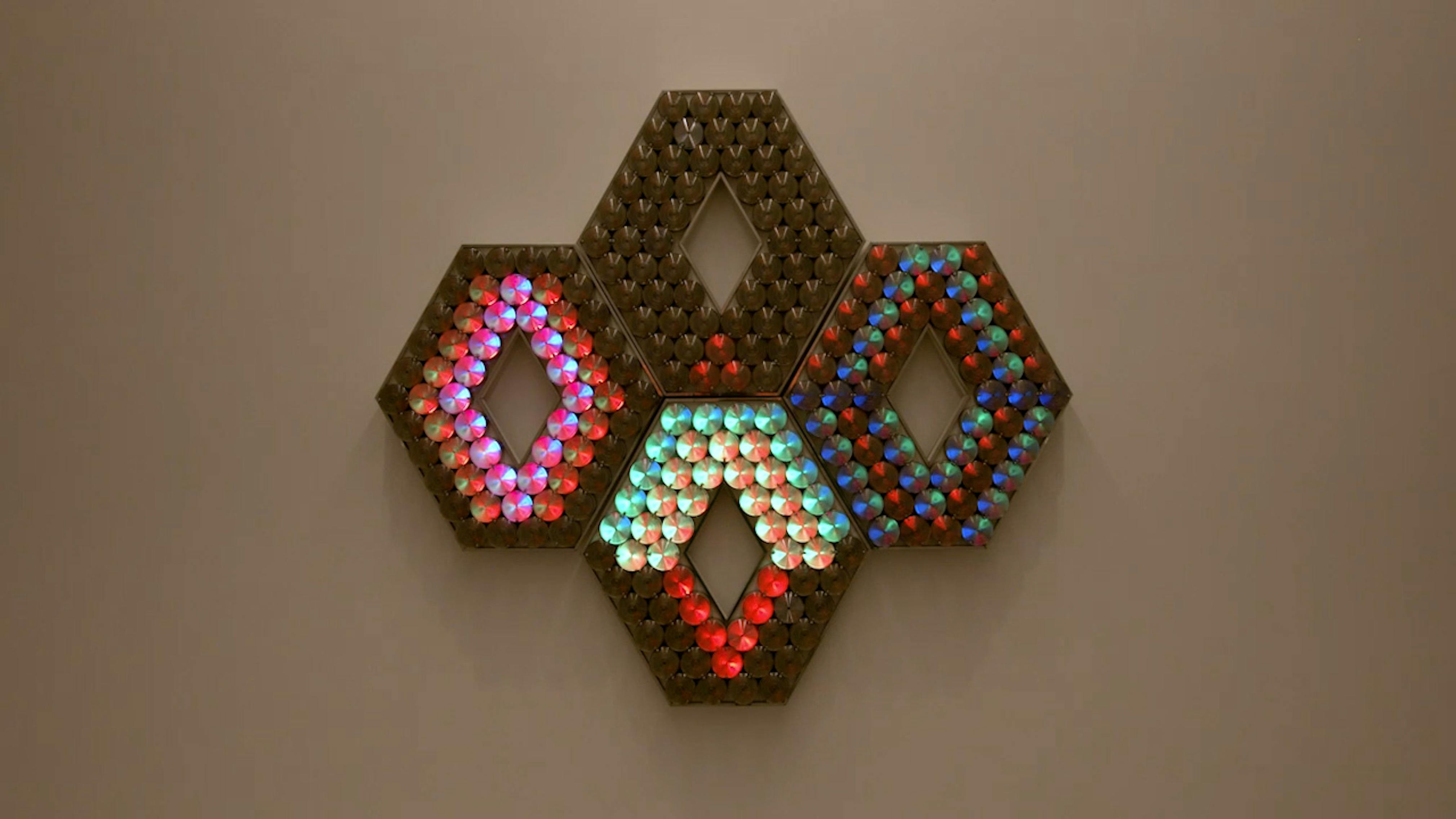 An electronically powered light sculpture with different color lightbulbs lighting up in different sequences.