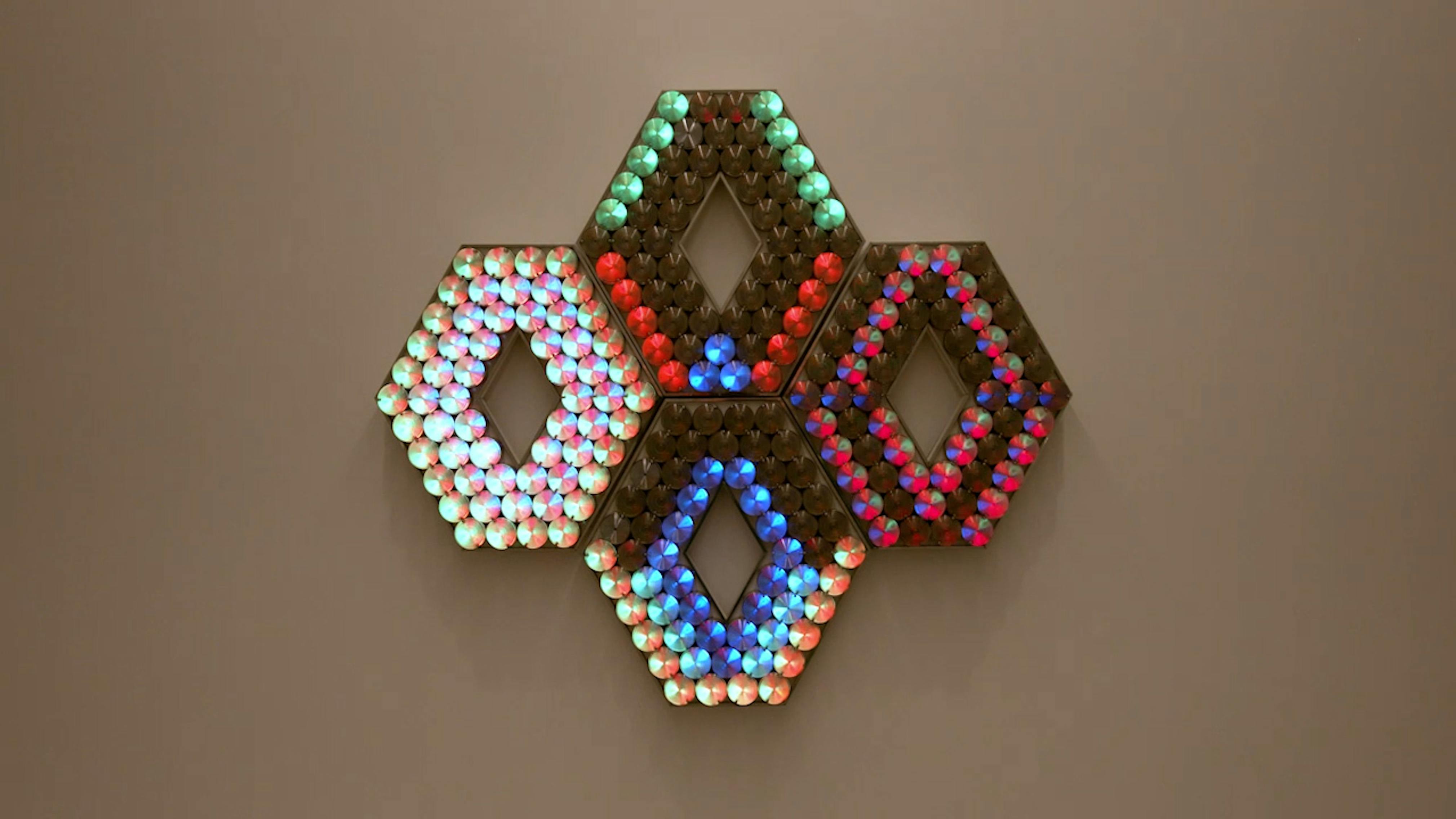 An electronically powered light sculpture with different color lightbulbs lighting up in different sequences.
