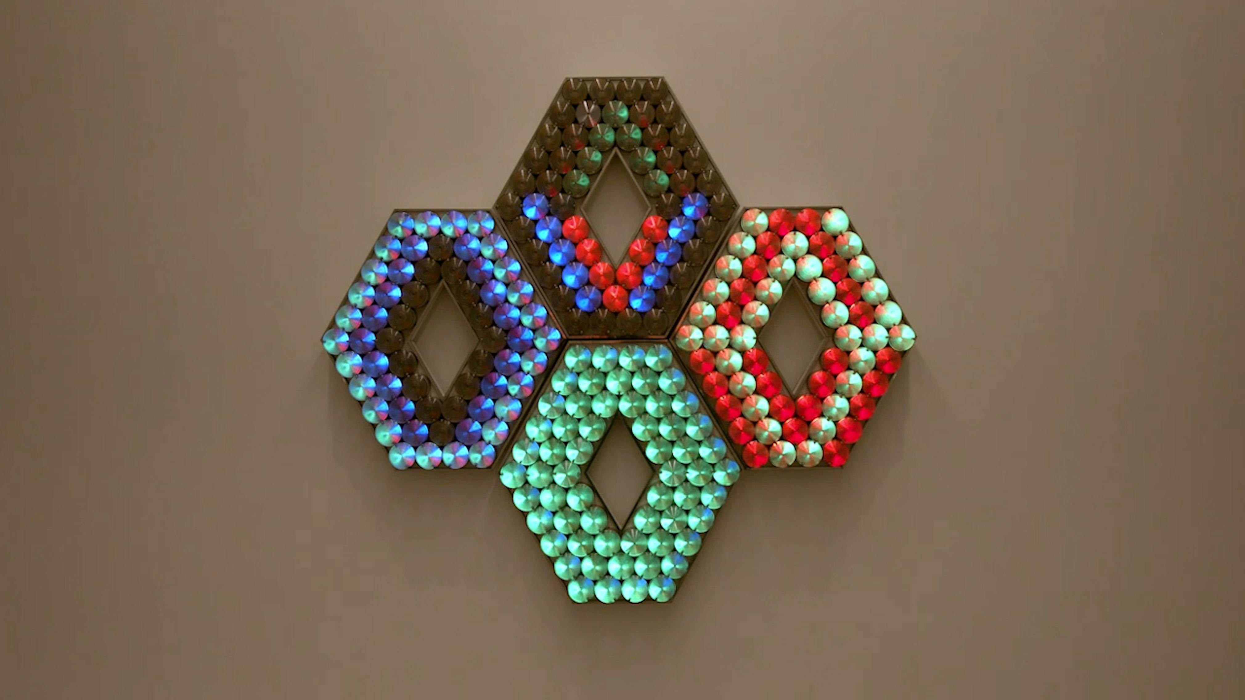 An electronically powered light sculpture with different color lightbulbs lighting up in different sequences.