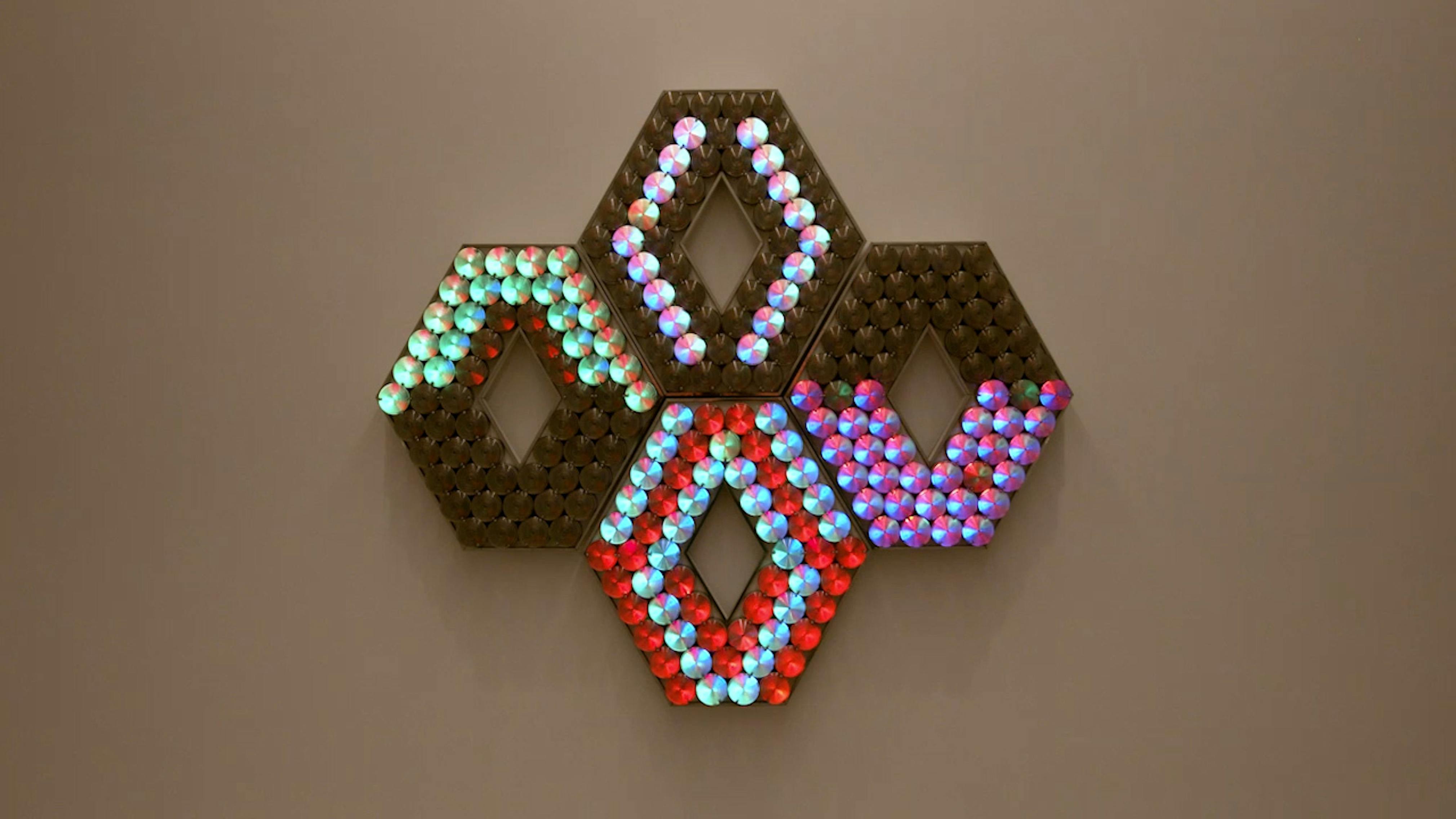 An electronically powered light sculpture with different color lightbulbs lighting up in different sequences.