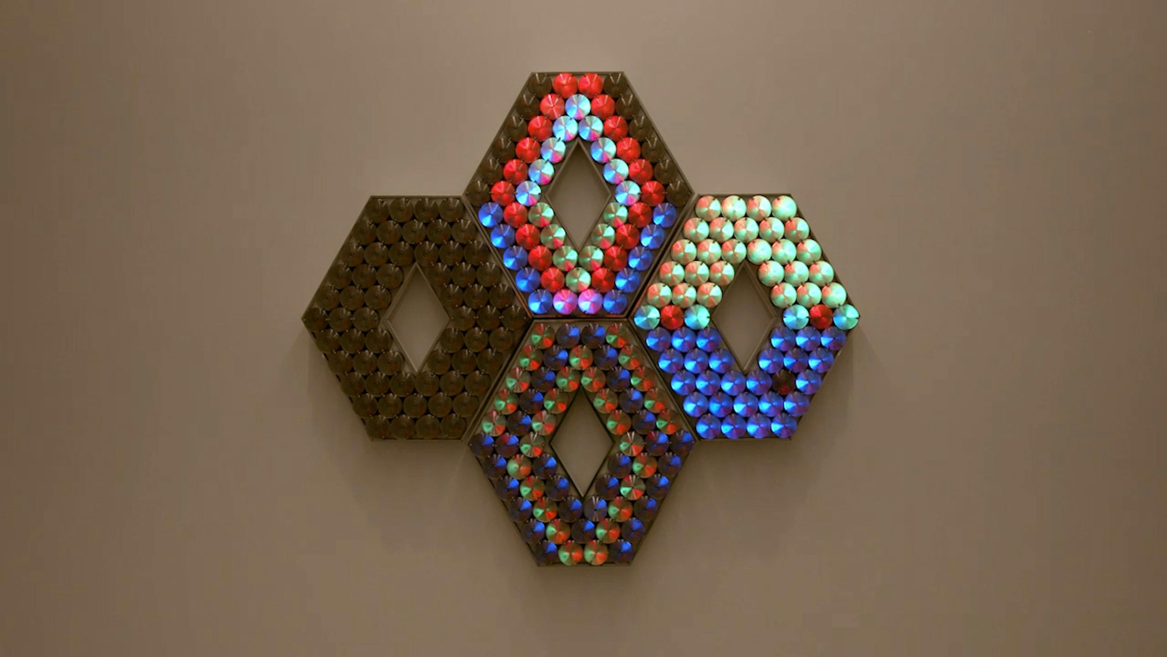 An electronically powered light sculpture with different color lightbulbs lighting up in different sequences.
