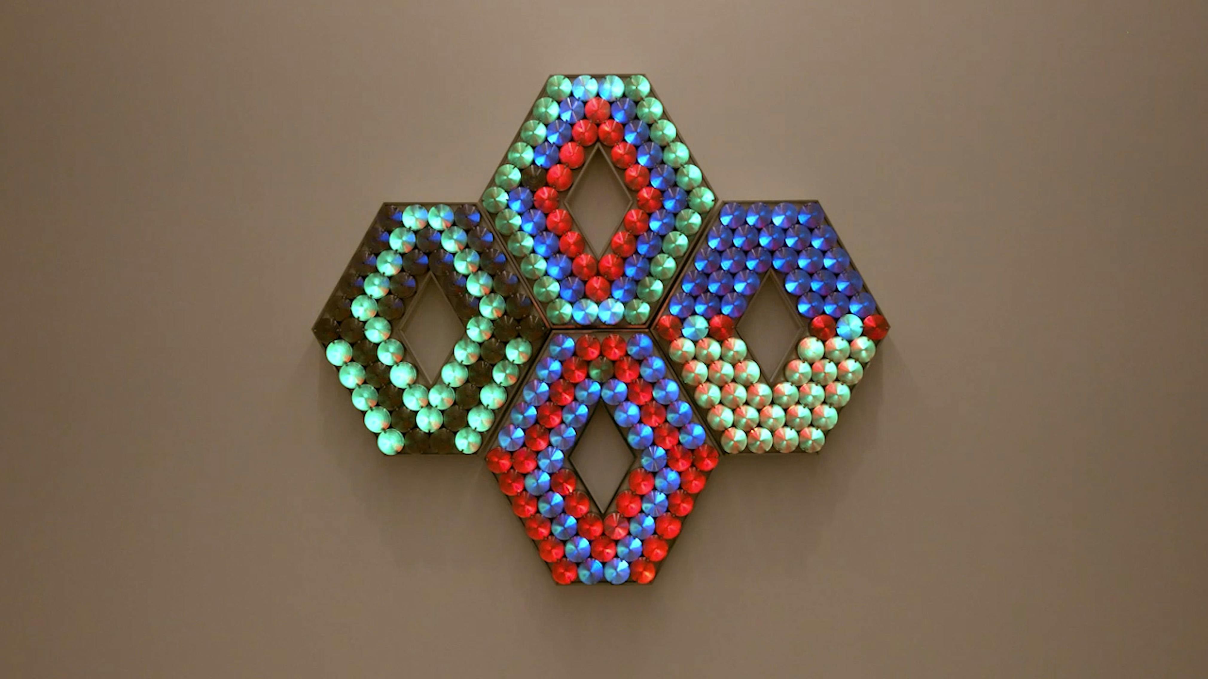 An electronically powered light sculpture with different color lightbulbs lighting up in different sequences.