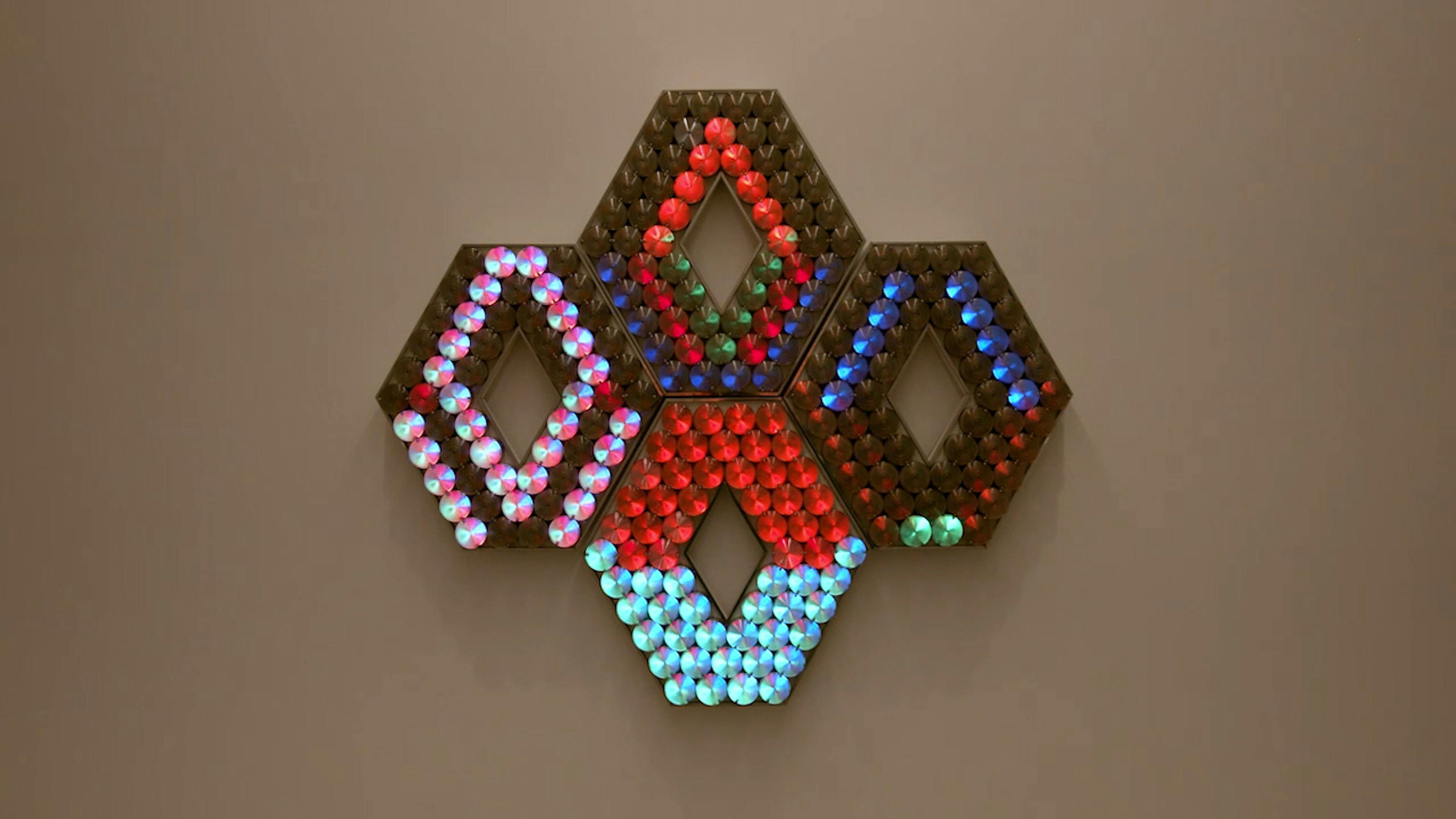 An electronically powered light sculpture with different color lightbulbs lighting up in different sequences.