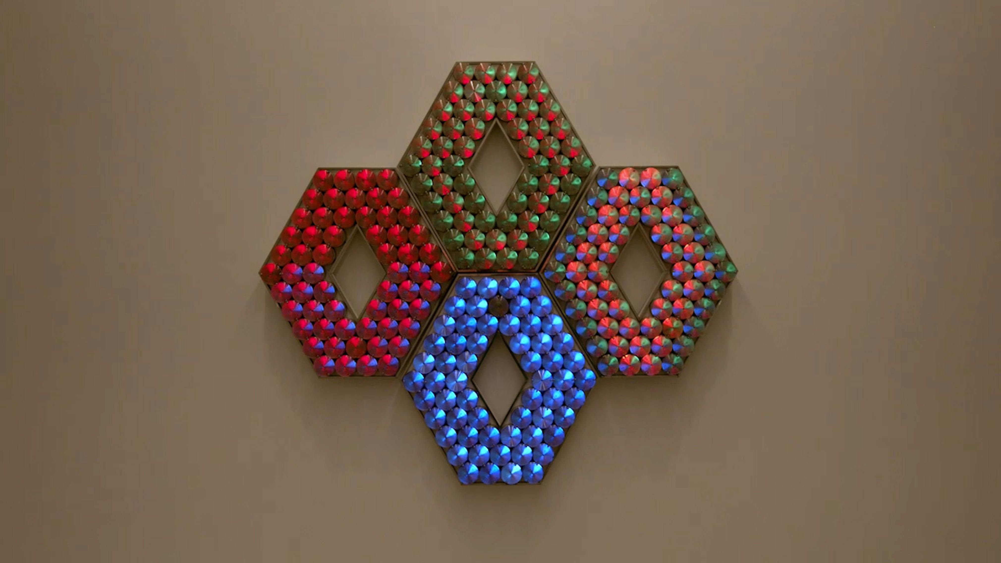 An electronically powered light sculpture with different color lightbulbs lighting up in different sequences.