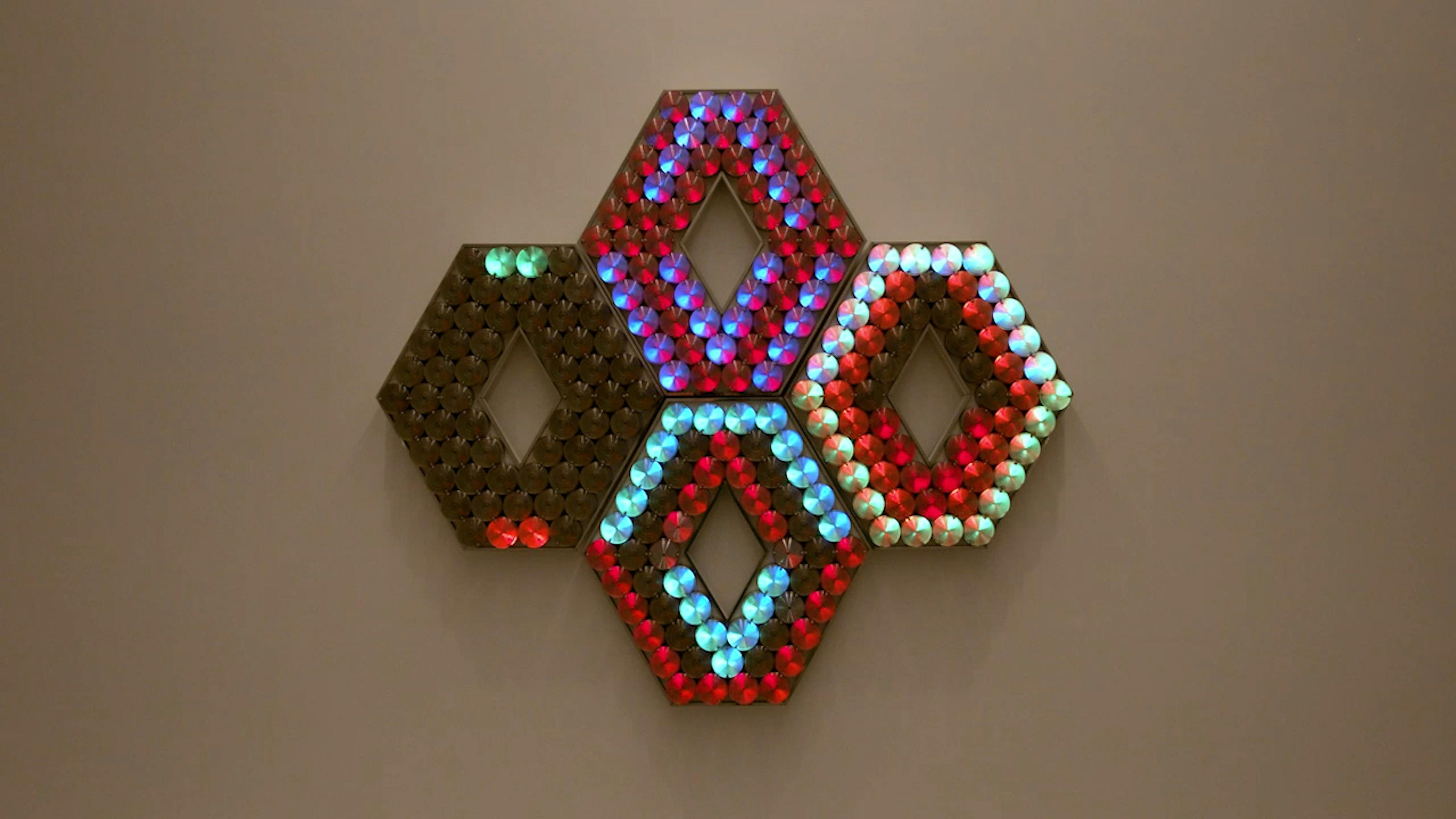 An electronically powered light sculpture with different color lightbulbs lighting up in different sequences.