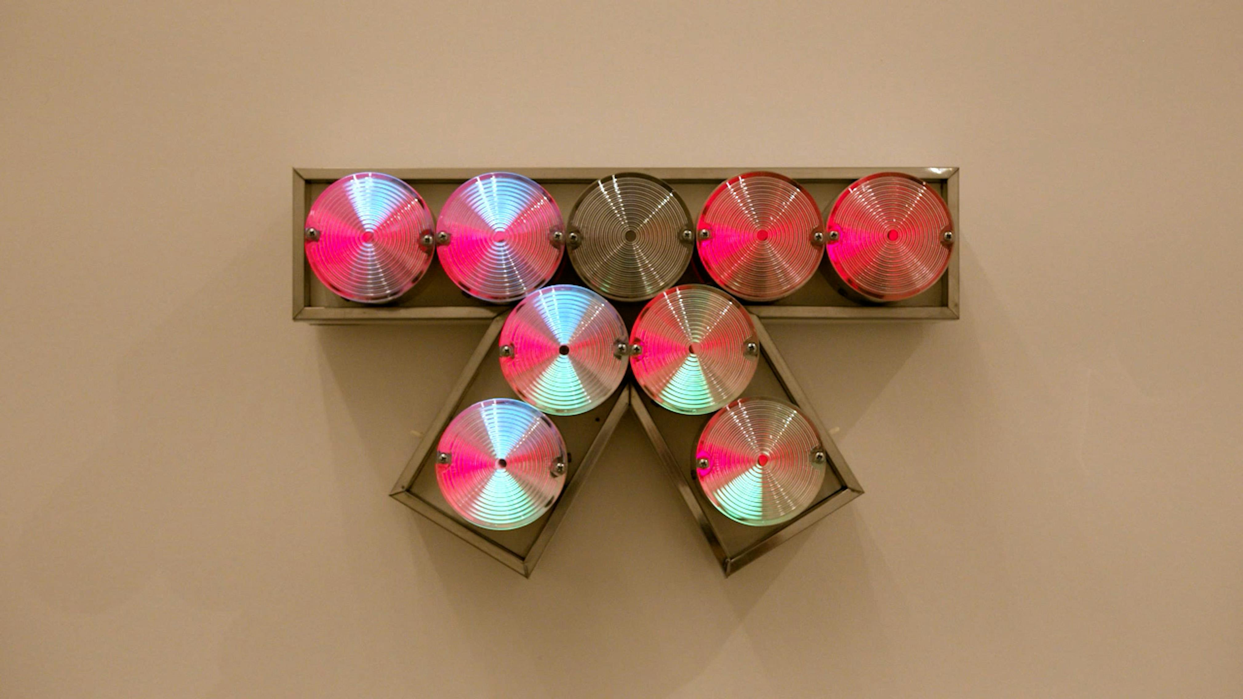 An electronically powered light sculpture with different color lightbulbs lighting up in different sequences.