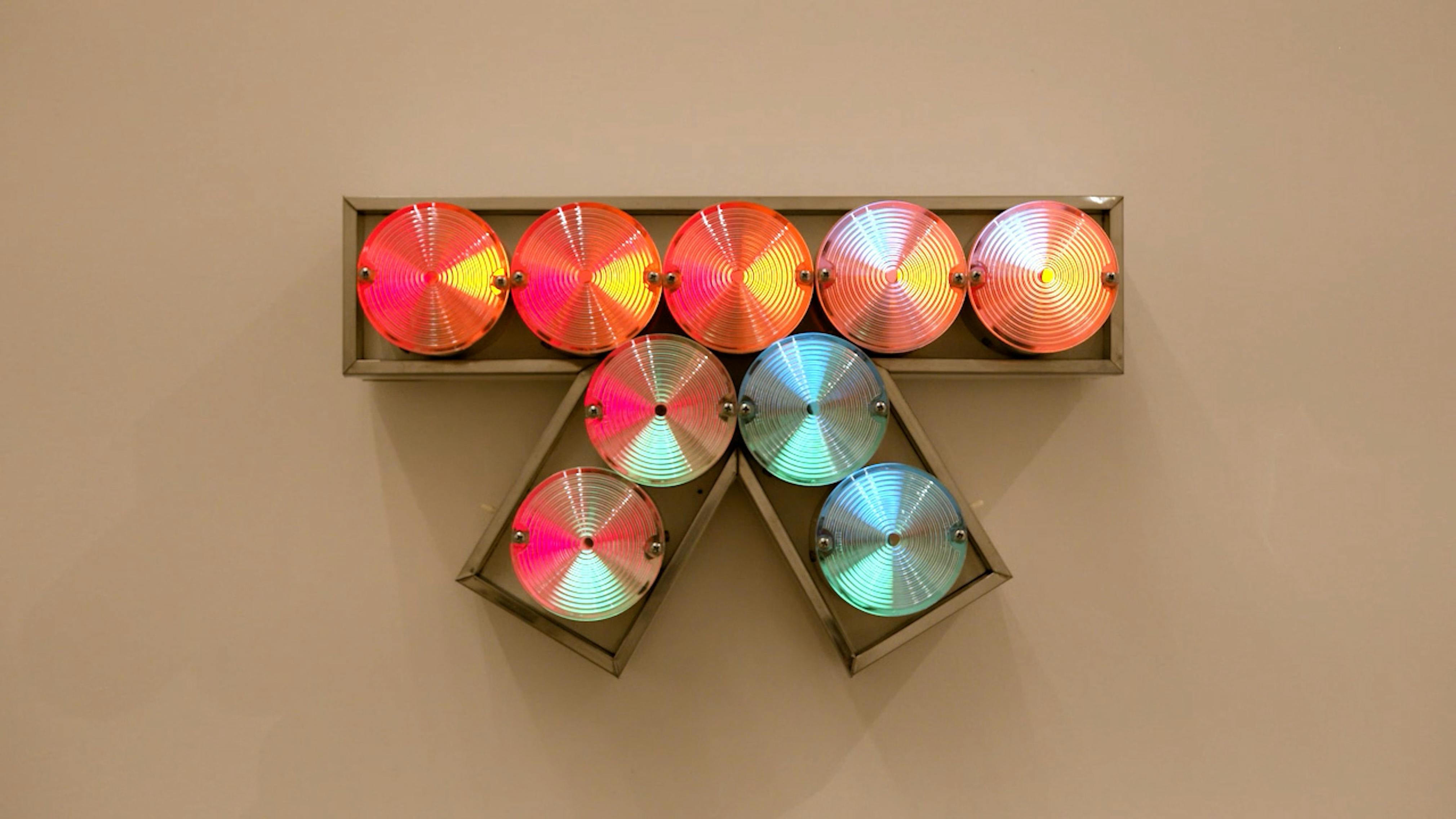 An electronically powered light sculpture with different color lightbulbs lighting up in different sequences.