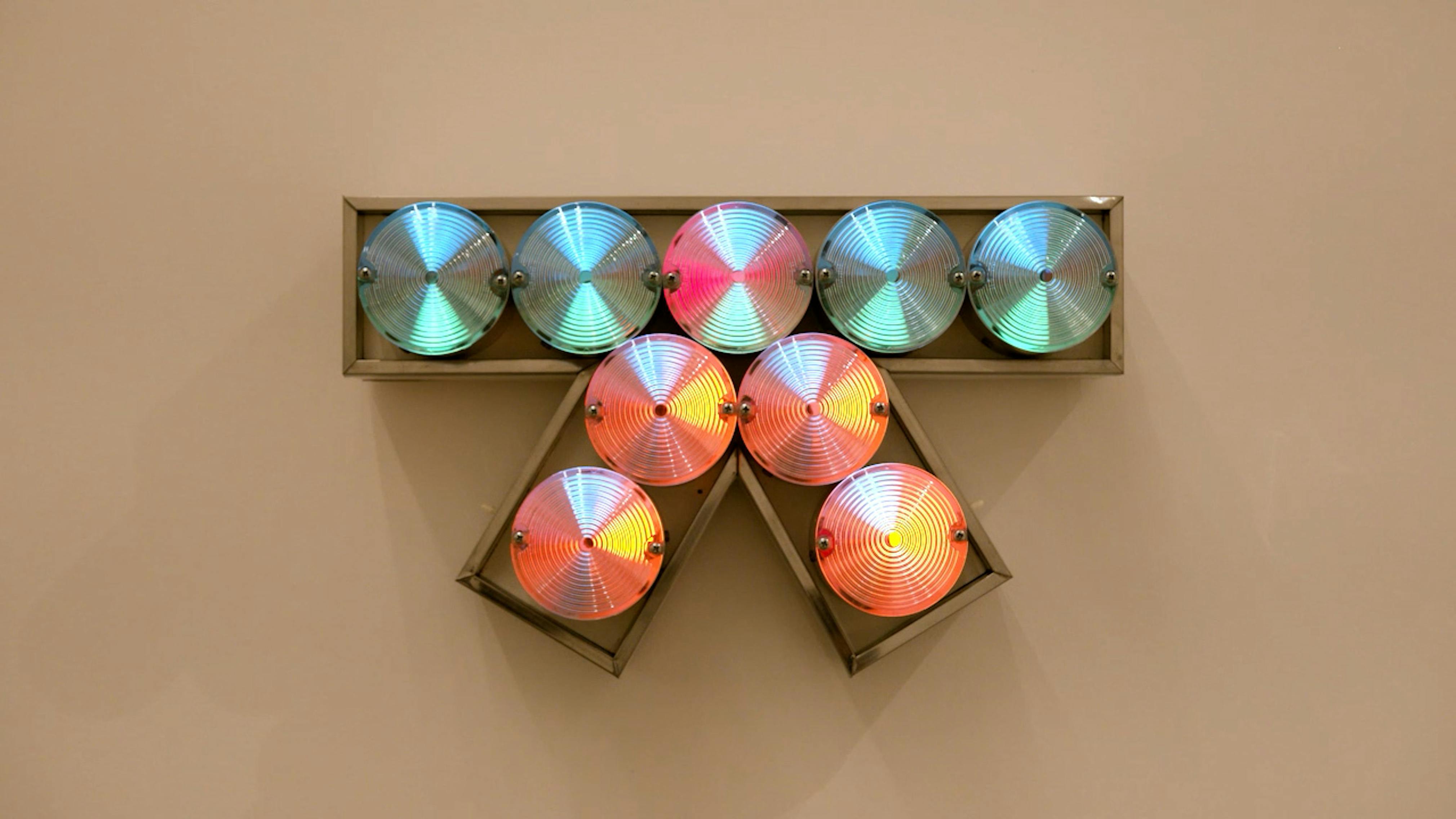An electronically powered light sculpture with different color lightbulbs lighting up in different sequences.