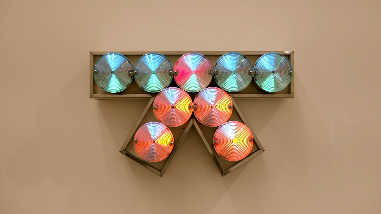 An electronically powered light sculpture with different color lightbulbs lighting up in different sequences.