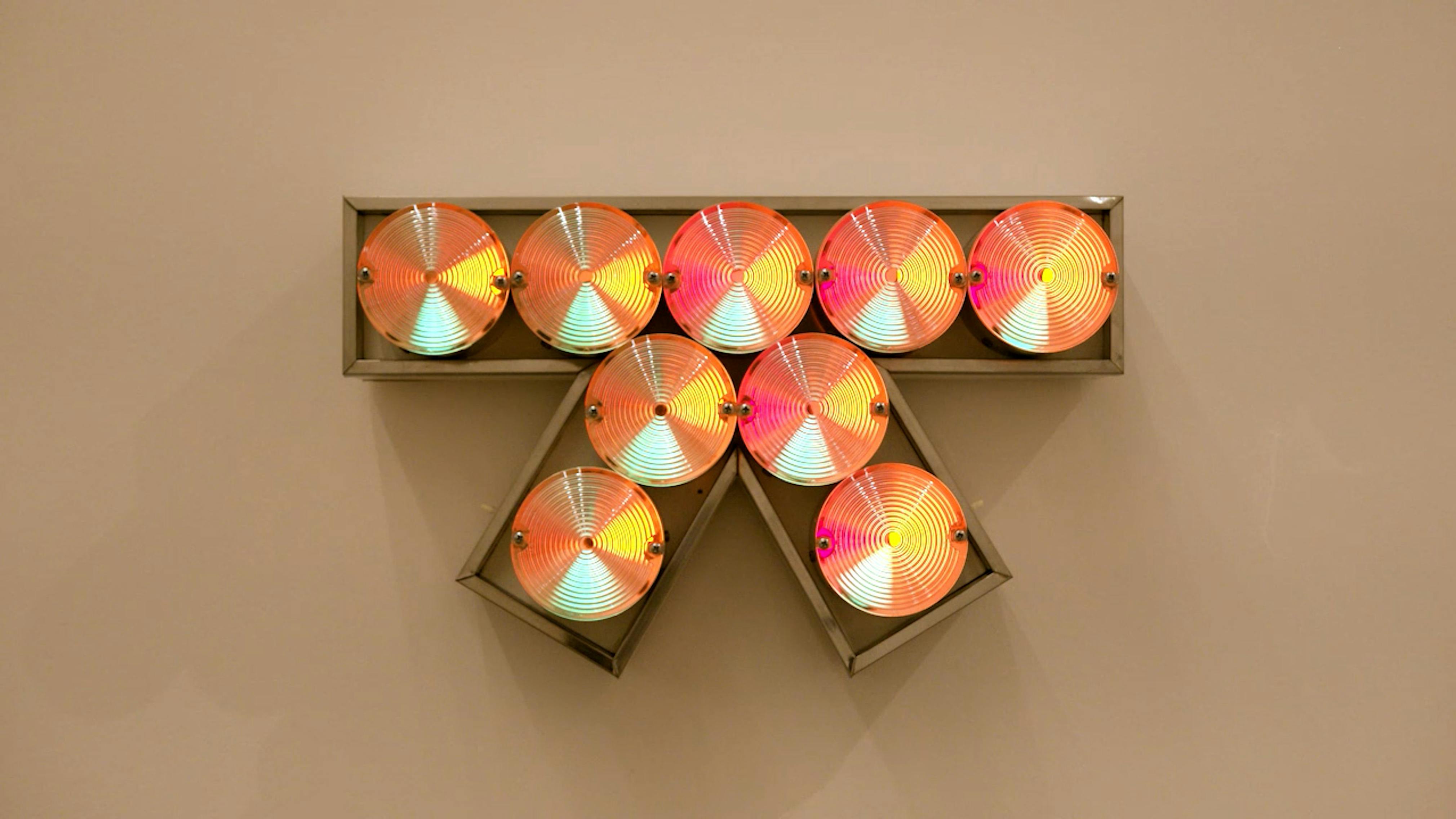 An electronically powered light sculpture with different color lightbulbs lighting up in different sequences.