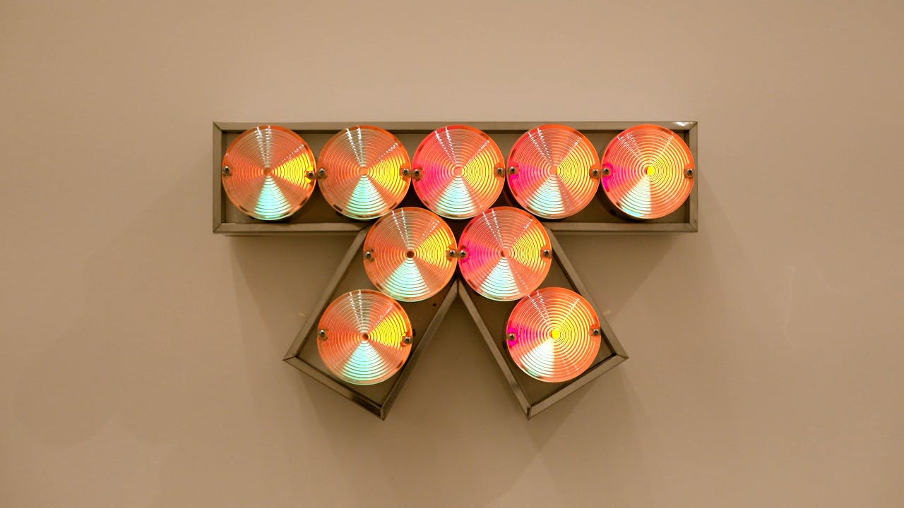 An electronically powered light sculpture with different color lightbulbs lighting up in different sequences.