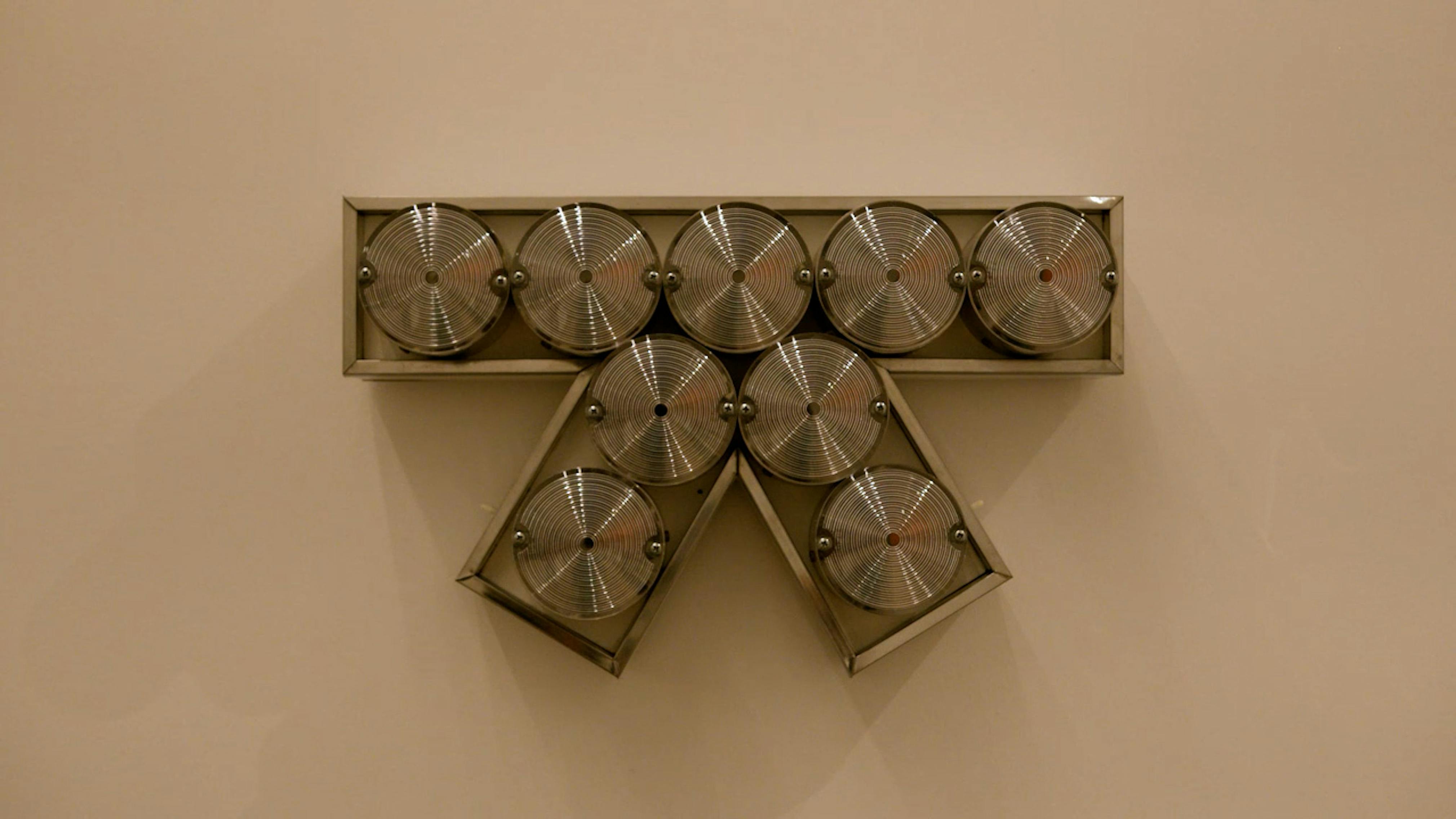 An electronically powered light sculpture with different color lightbulbs lighting up in different sequences.