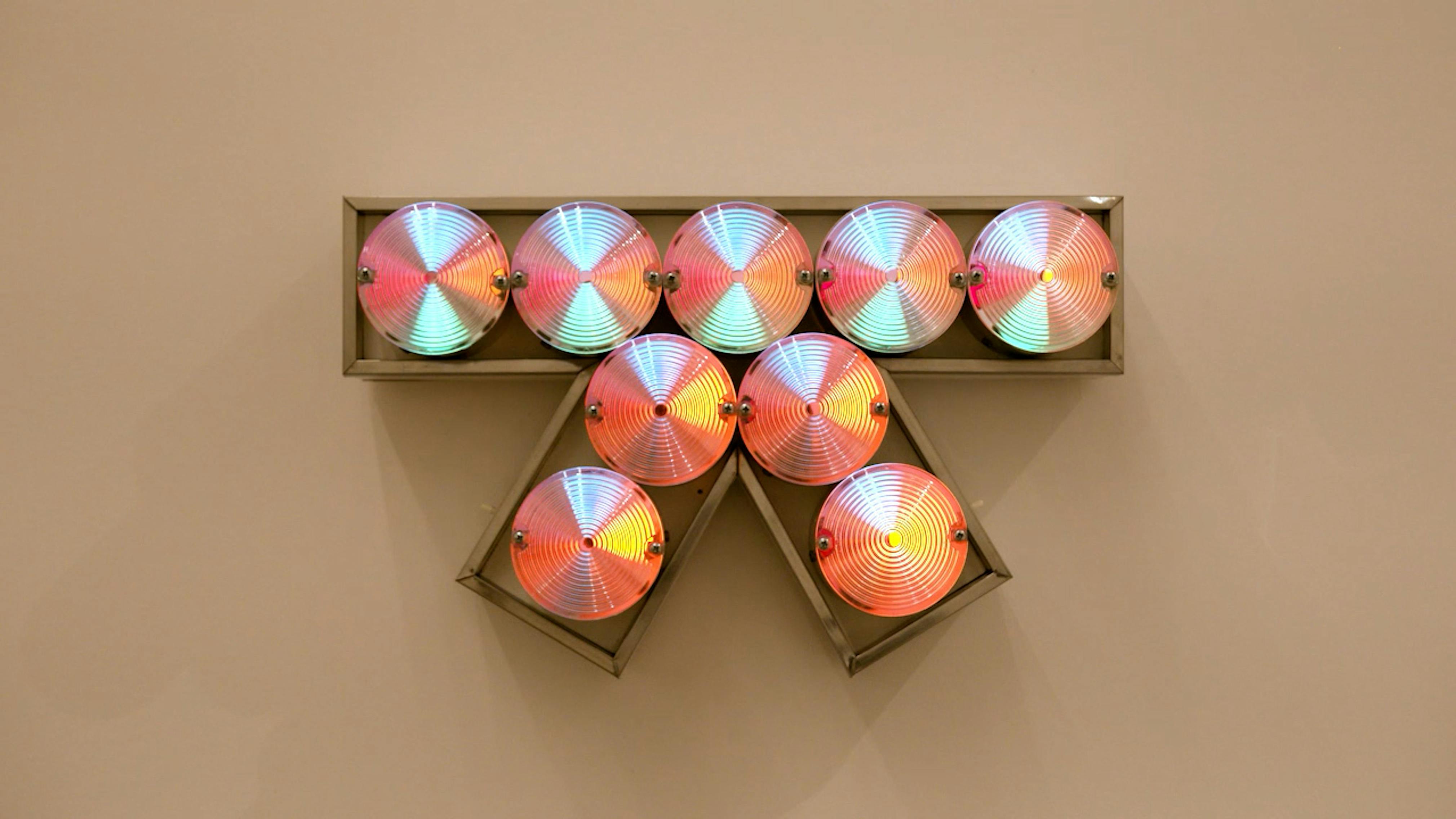 An electronically powered light sculpture with different color lightbulbs lighting up in different sequences.