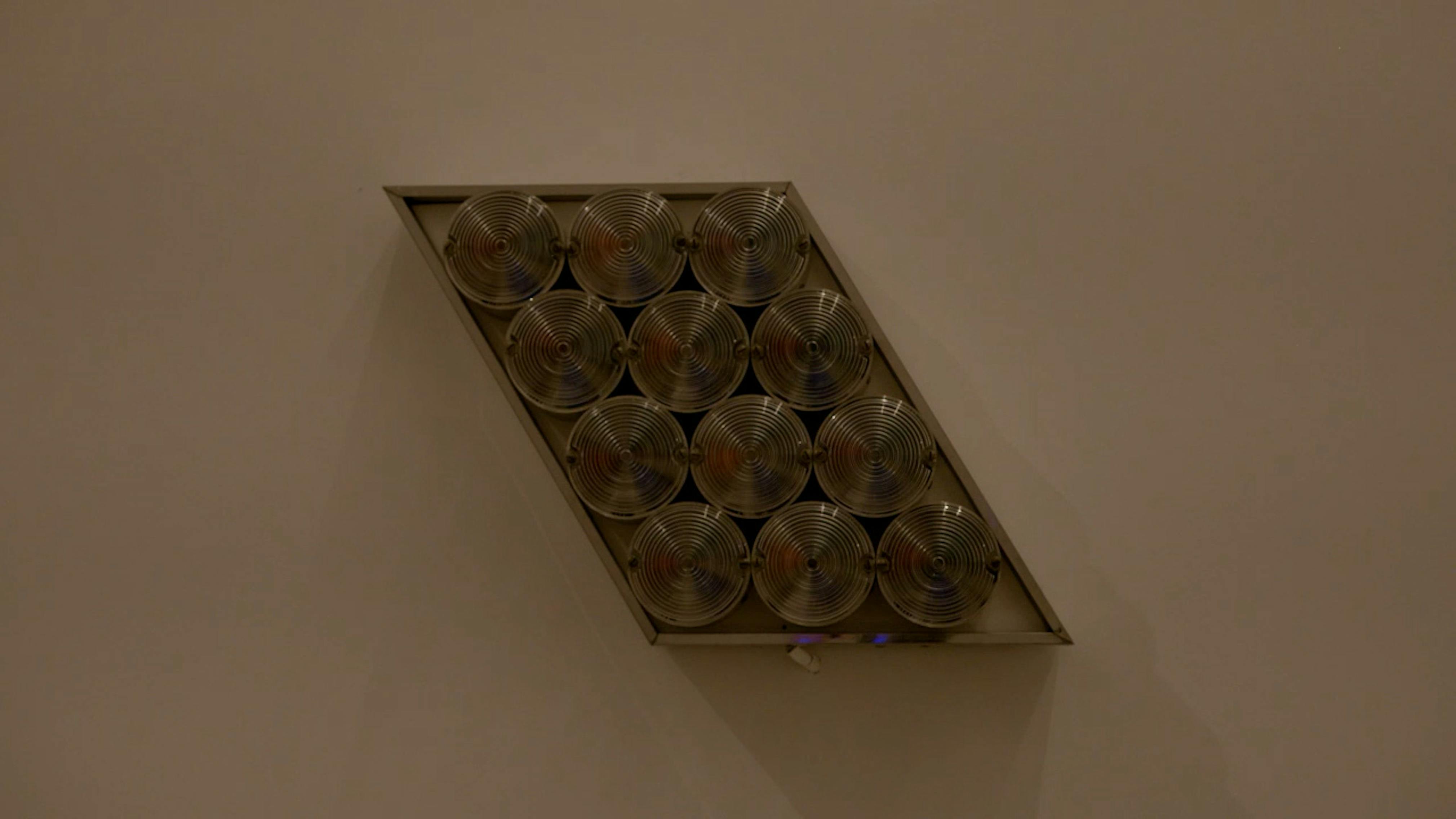 An electronically powered light sculpture with different color lightbulbs lighting up in different sequences.