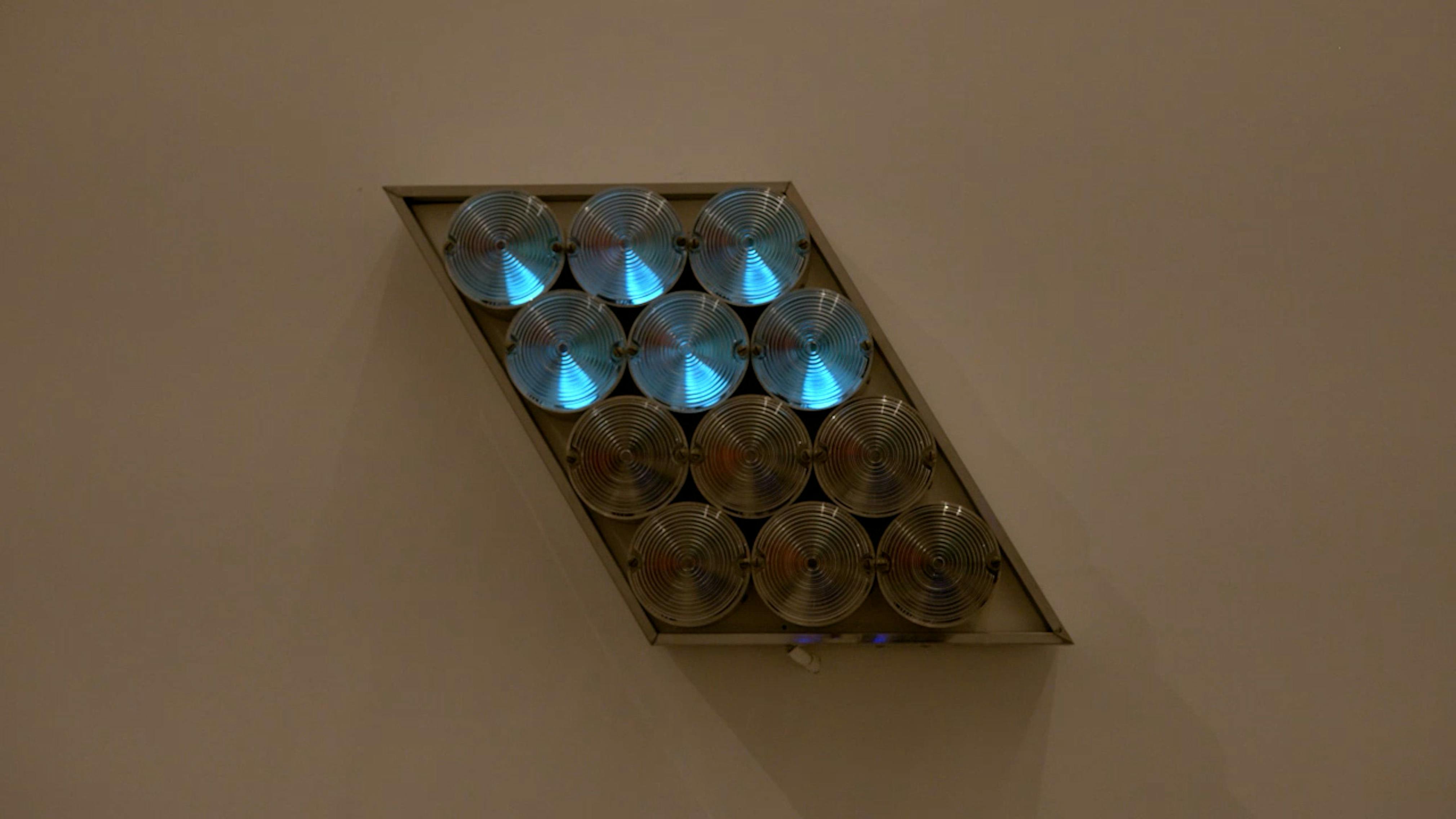 An electronically powered light sculpture with different color lightbulbs lighting up in different sequences.