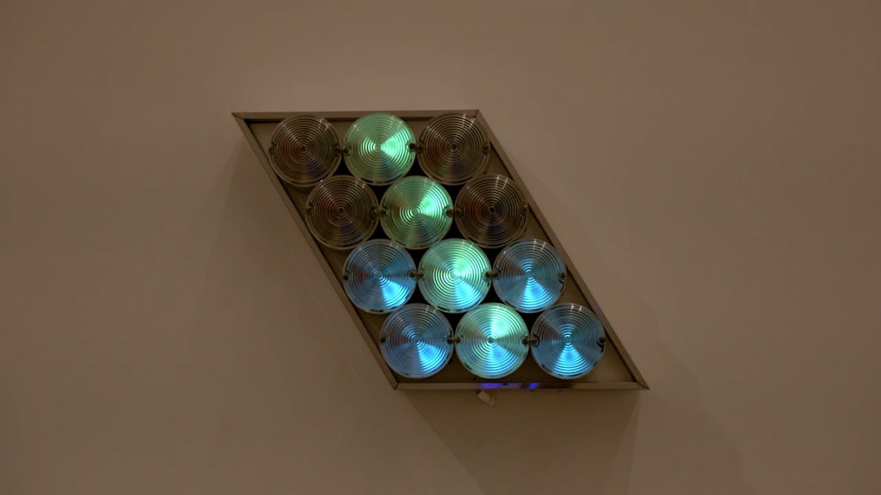 An electronically powered light sculpture with different color lightbulbs lighting up in different sequences.