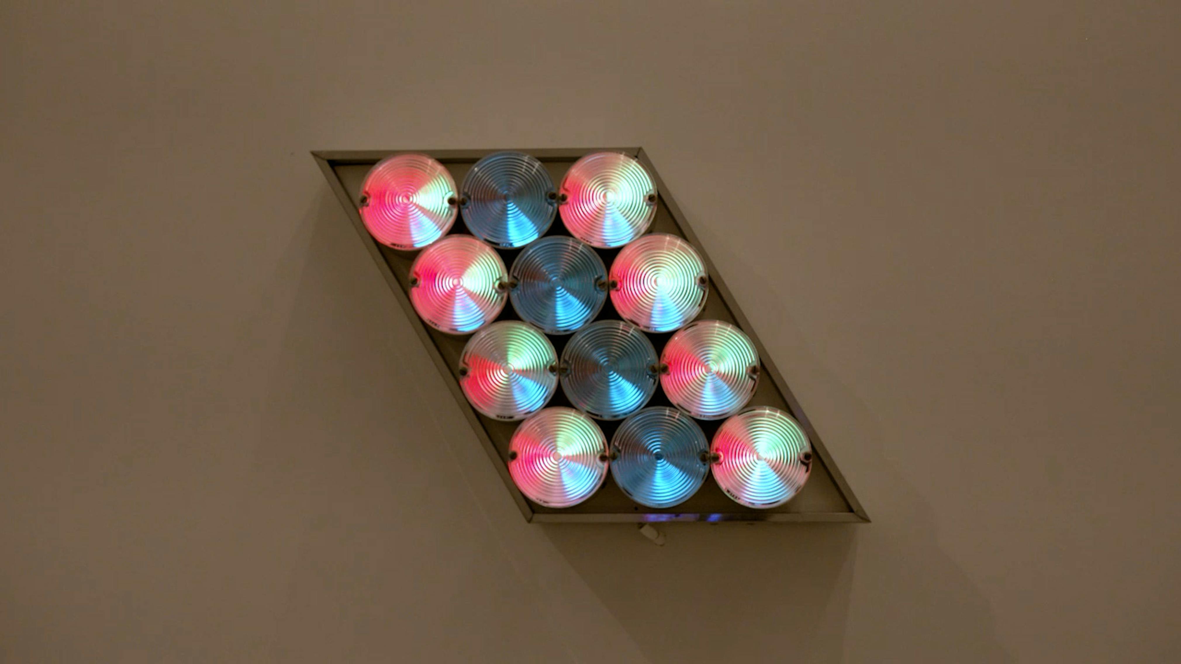 An electronically powered light sculpture with different color lightbulbs lighting up in different sequences.