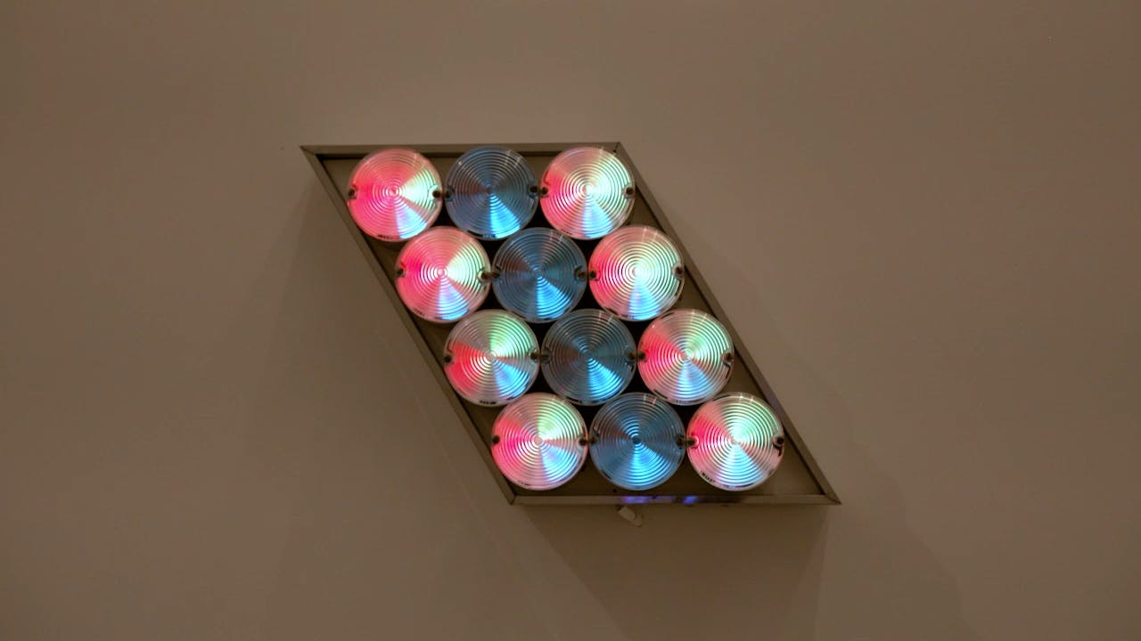 An electronically powered light sculpture with different color lightbulbs lighting up in different sequences.