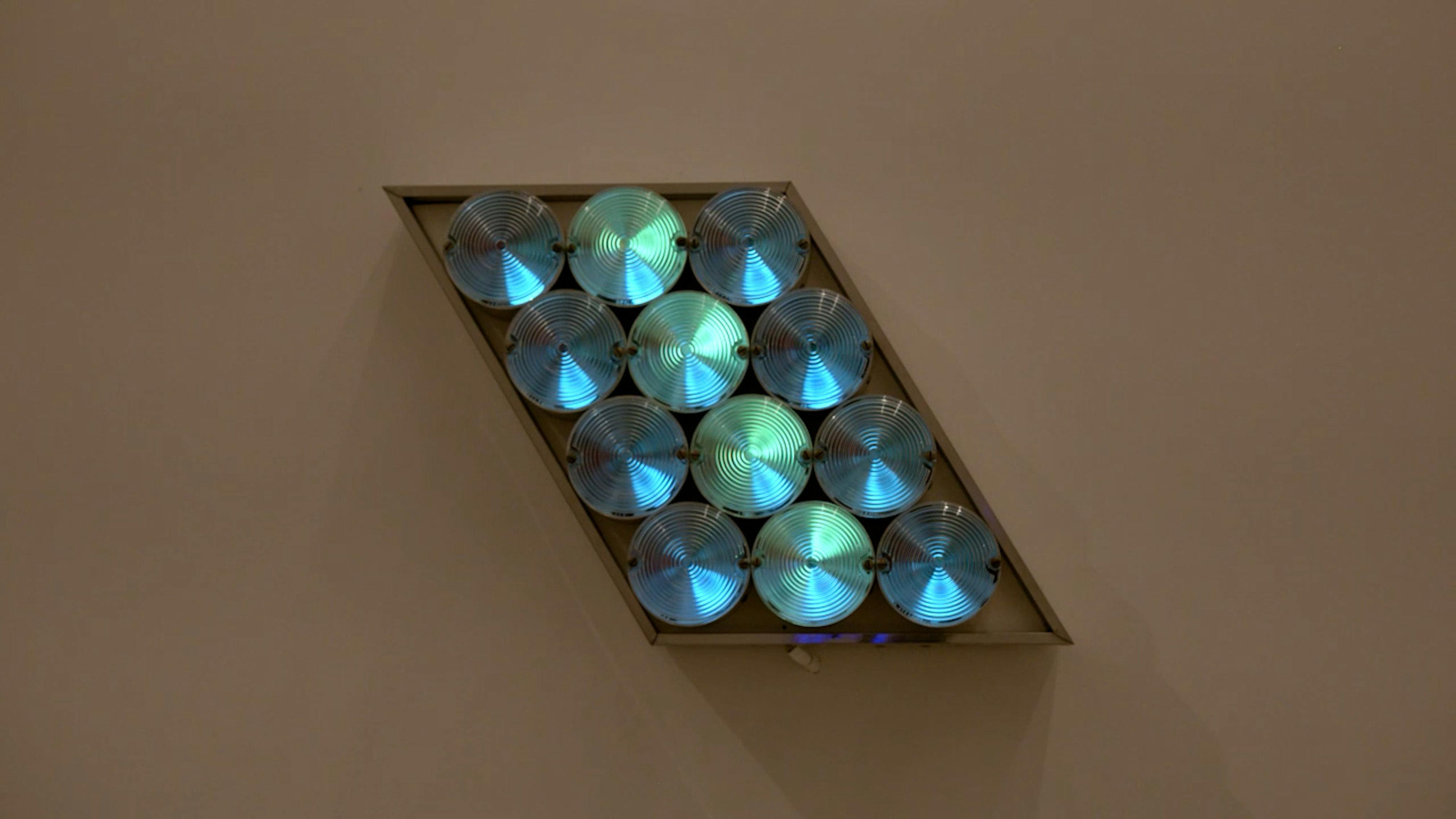An electronically powered light sculpture with different color lightbulbs lighting up in different sequences.