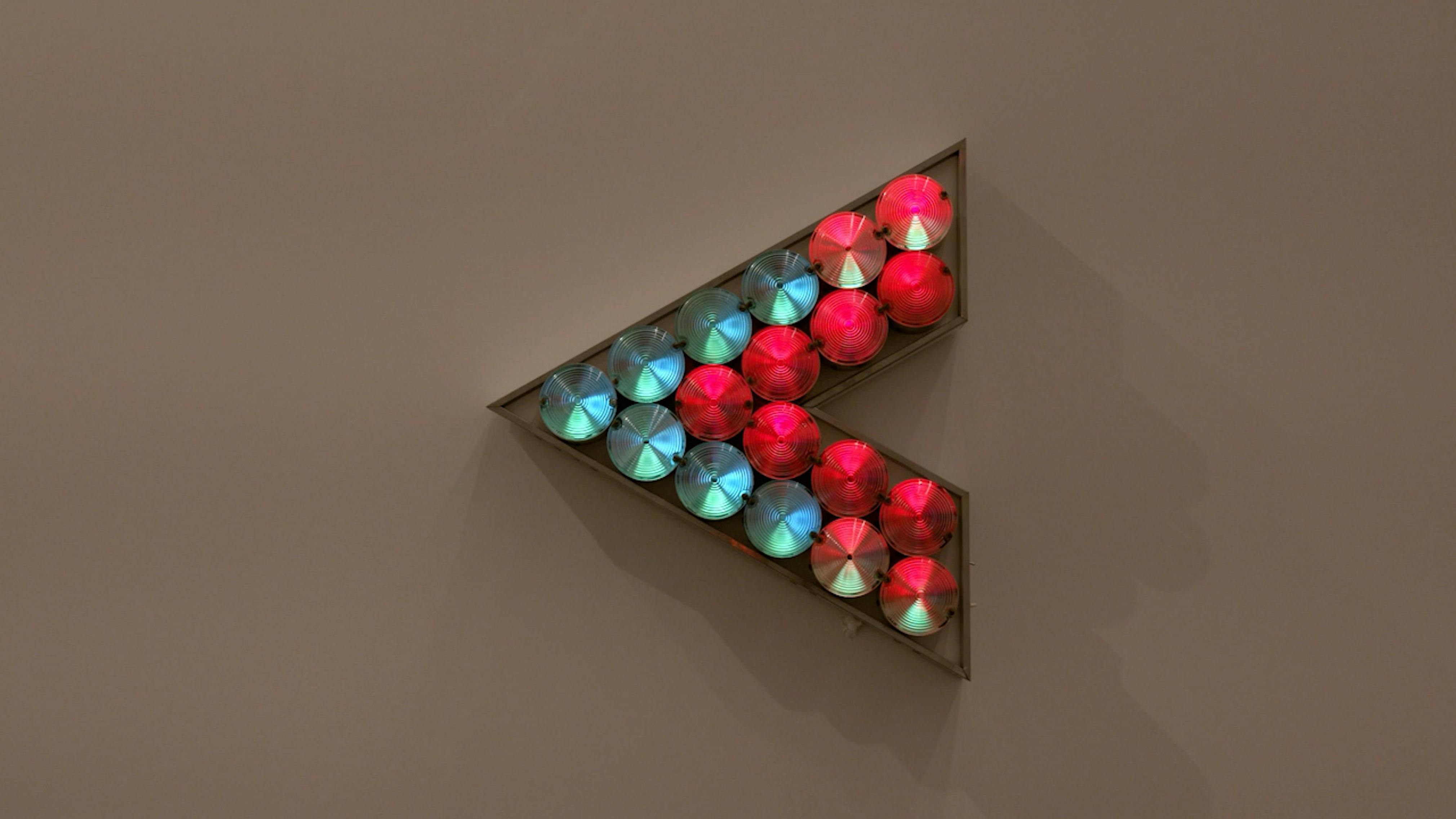 An electronically powered light sculpture with different color lightbulbs lighting up in different sequences.