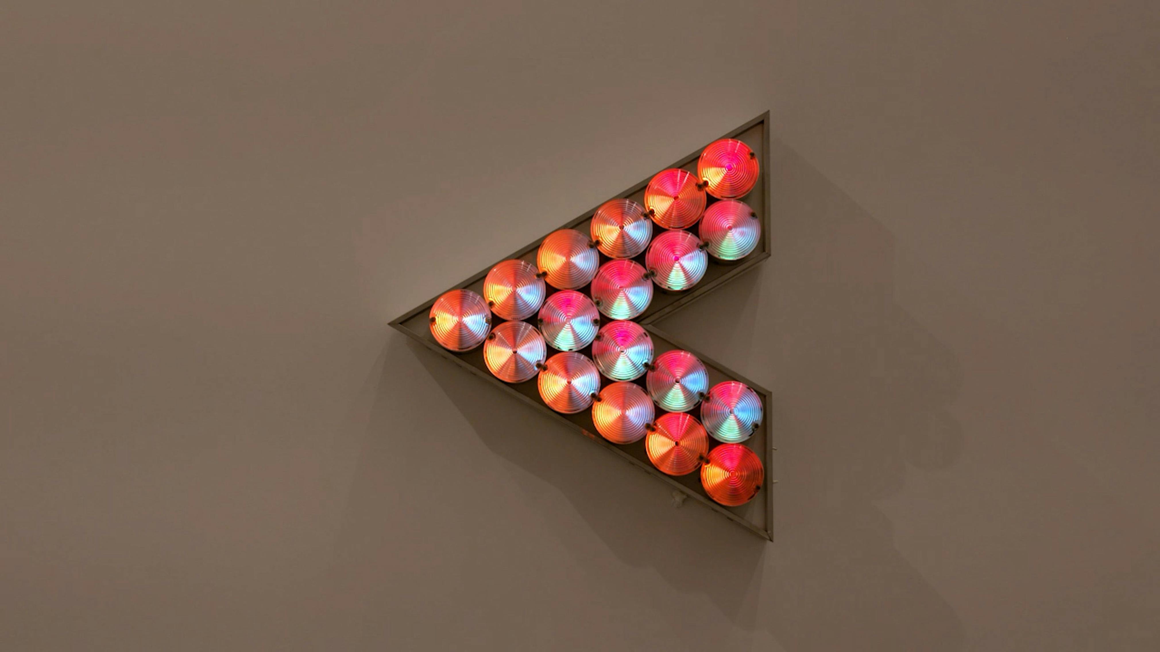 An electronically powered light sculpture with different color lightbulbs lighting up in different sequences.