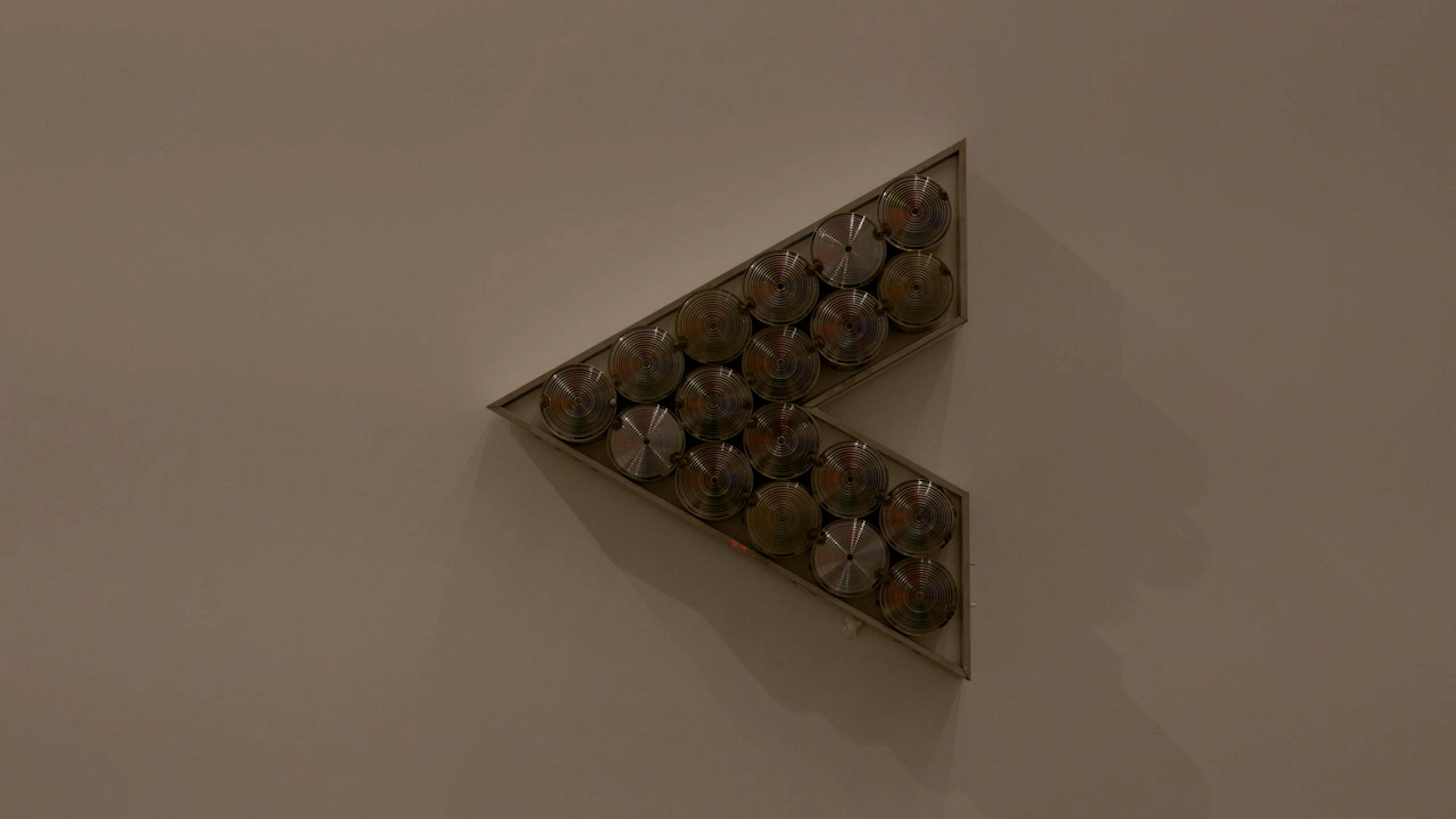 An electronically powered light sculpture with different color lightbulbs lighting up in different sequences.