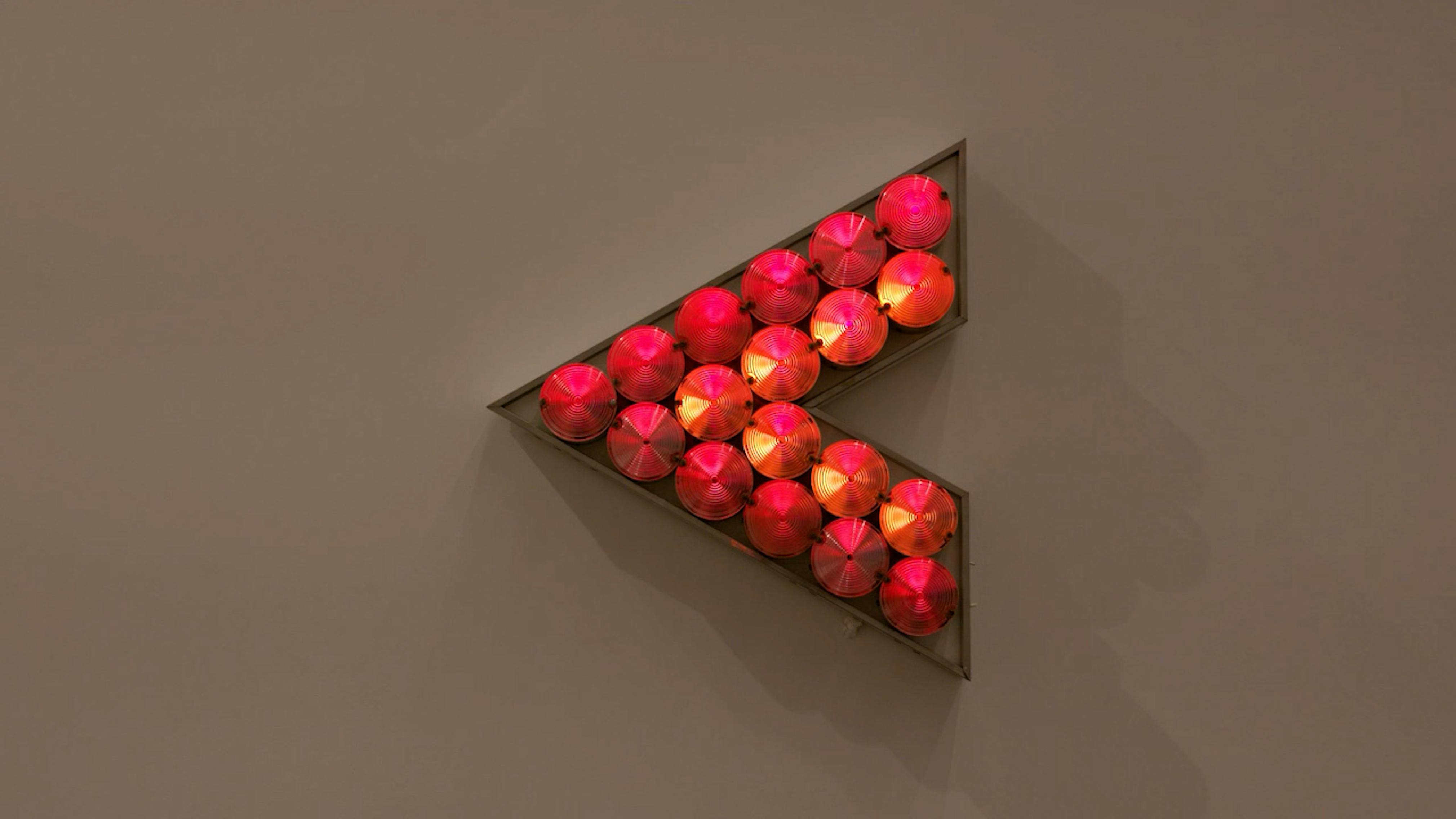 An electronically powered light sculpture with different color lightbulbs lighting up in different sequences.