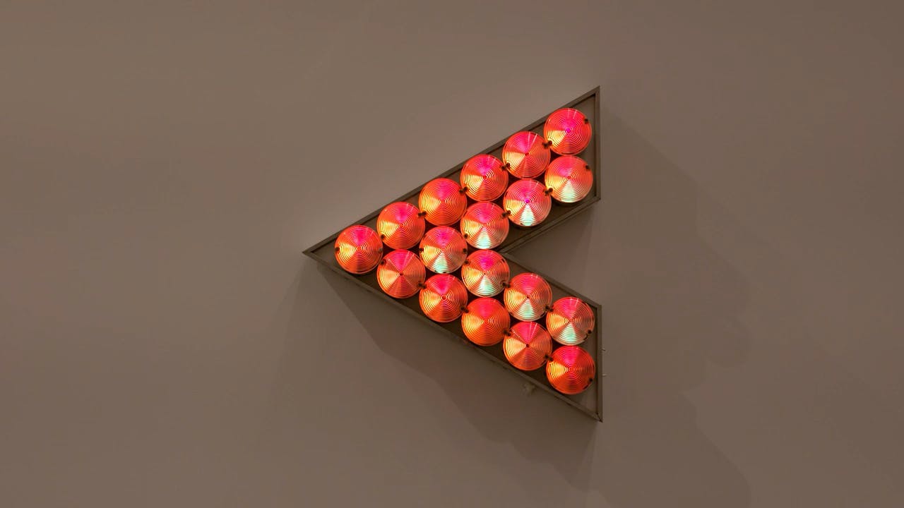 An electronically powered light sculpture with different color lightbulbs lighting up in different sequences.