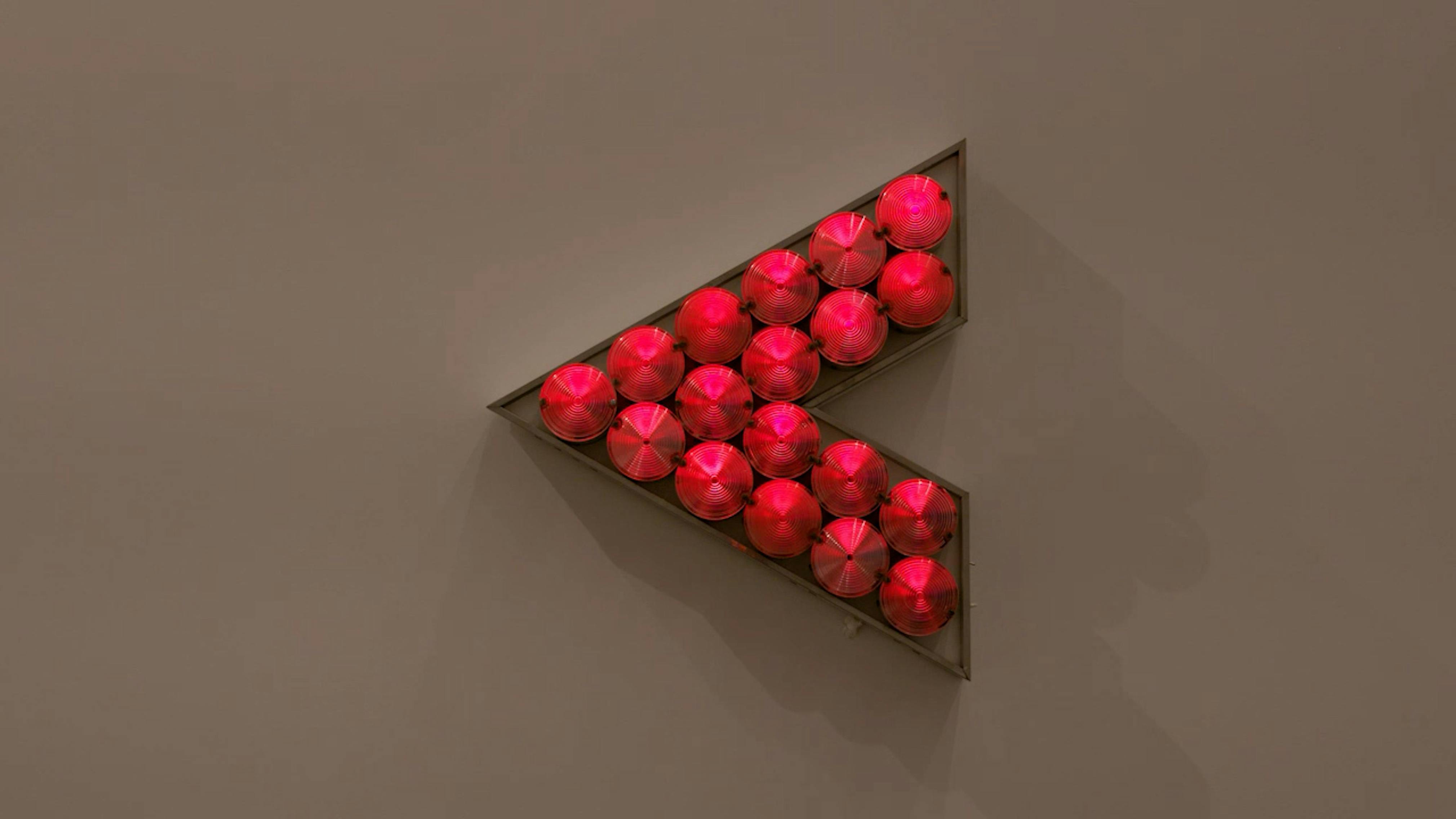 An electronically powered light sculpture with different color lightbulbs lighting up in different sequences.