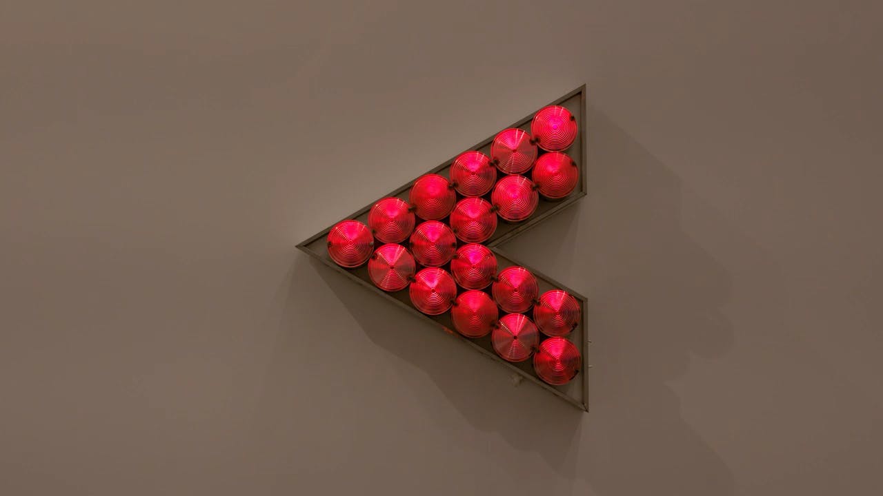 An electronically powered light sculpture with different color lightbulbs lighting up in different sequences.