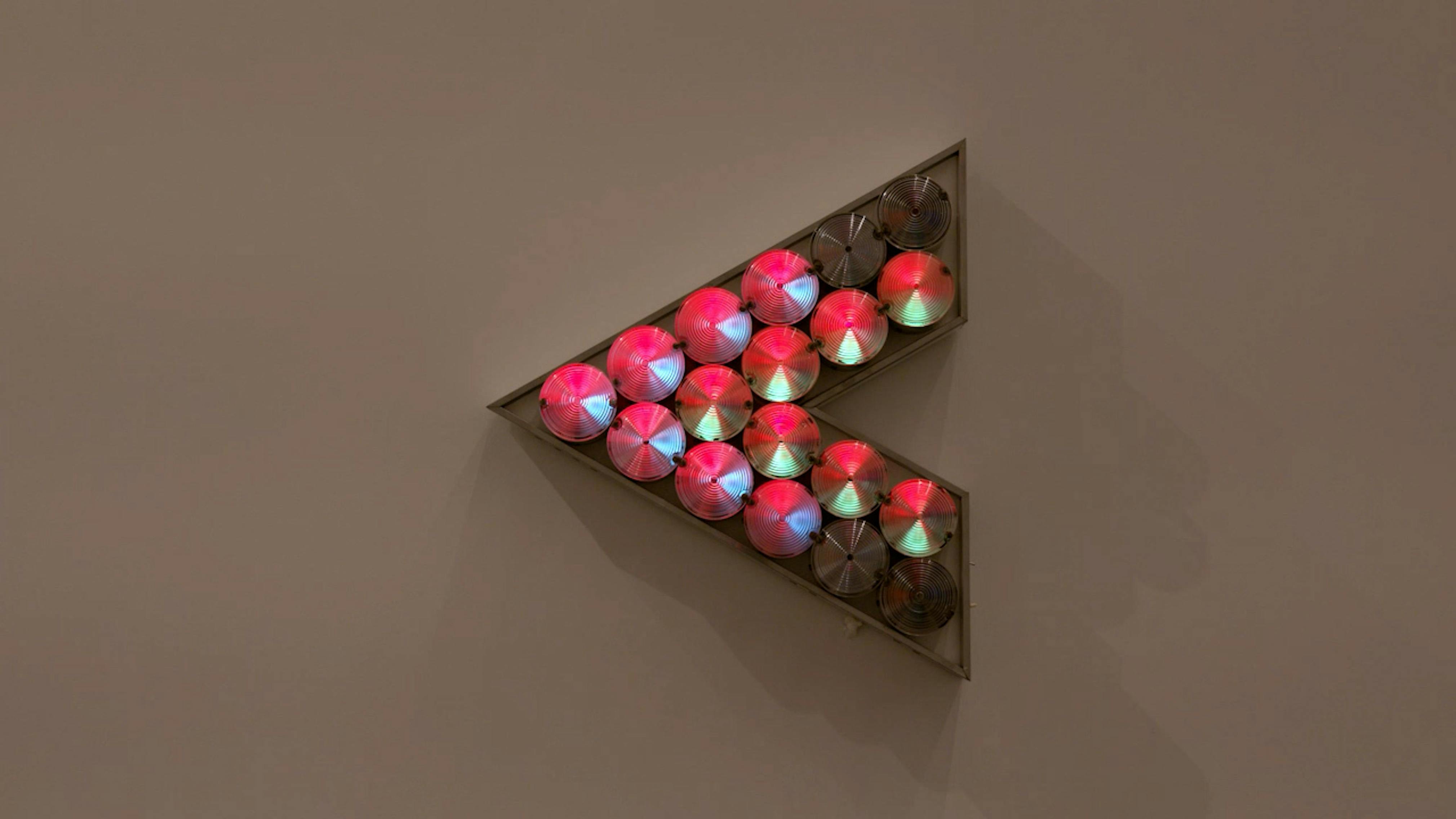 An electronically powered light sculpture with different color lightbulbs lighting up in different sequences.