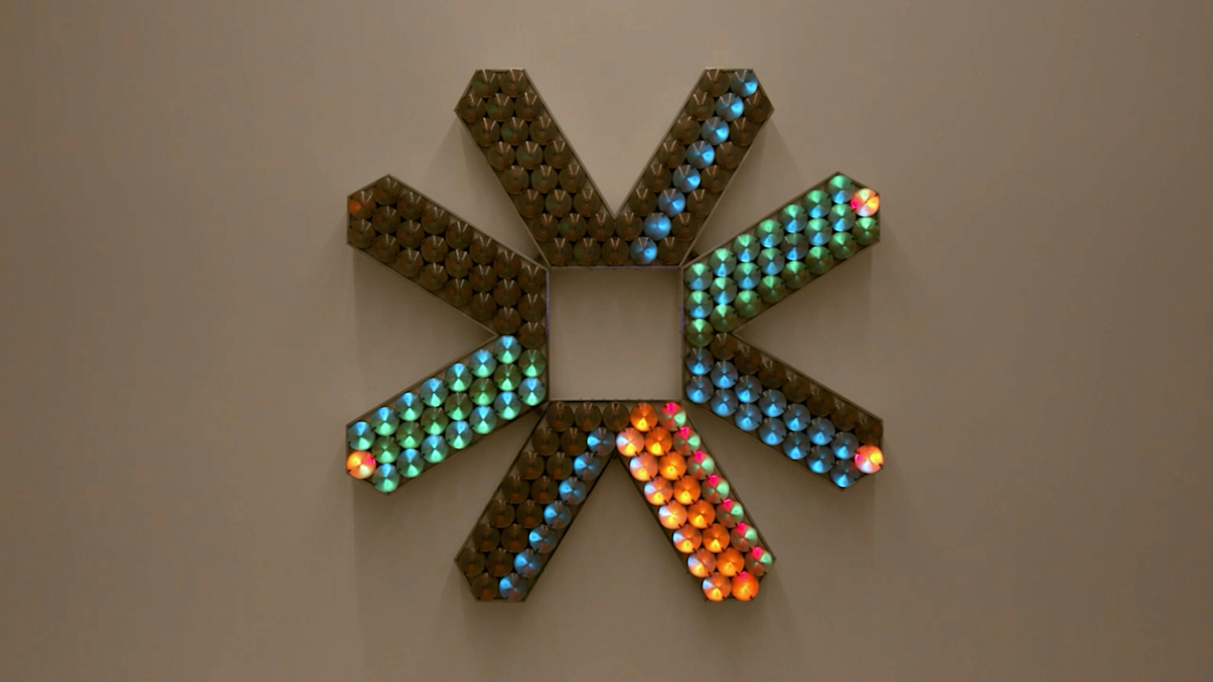 An electronically powered light sculpture with different color lightbulbs lighting up in different sequences.