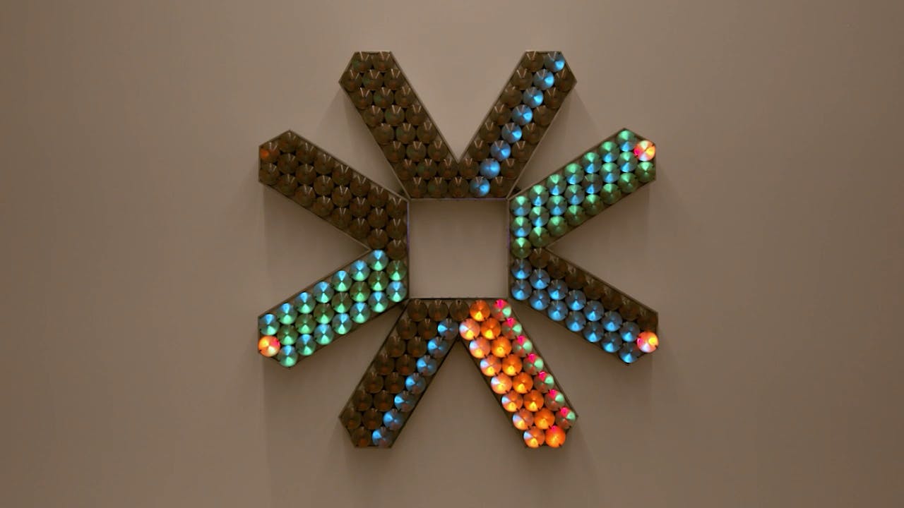 An electronically powered light sculpture with different color lightbulbs lighting up in different sequences.